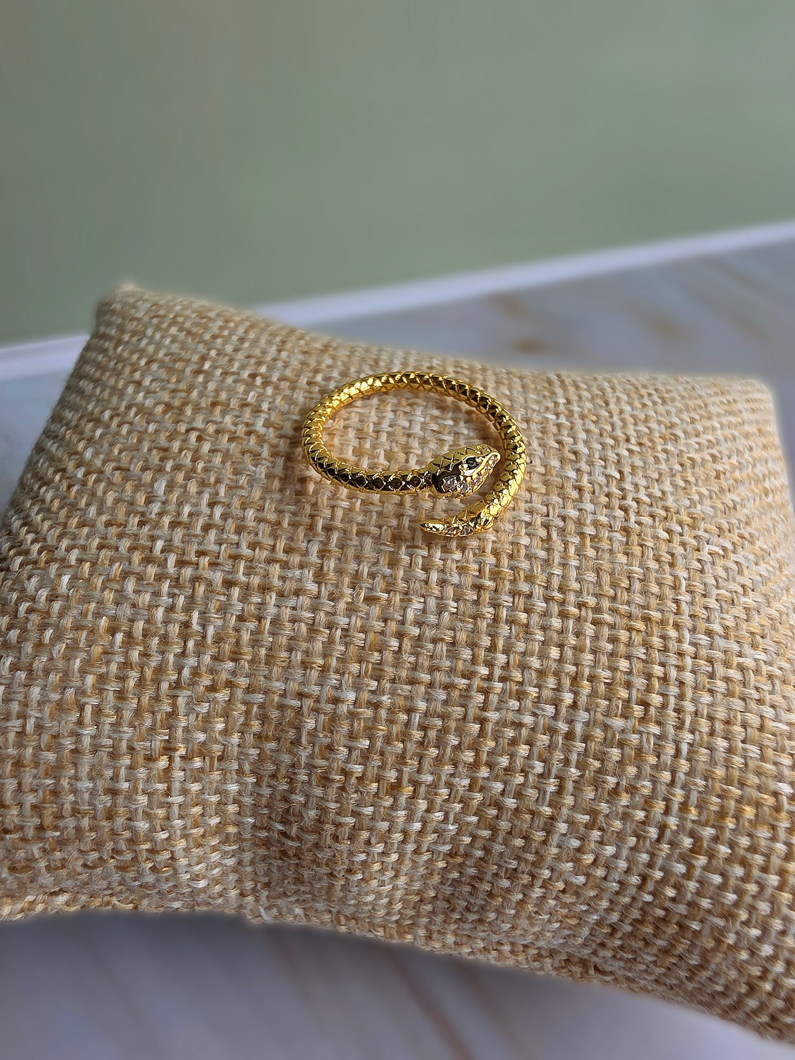 Minimalist serpent ring with black crystal eyes and sparkling CZ accents.