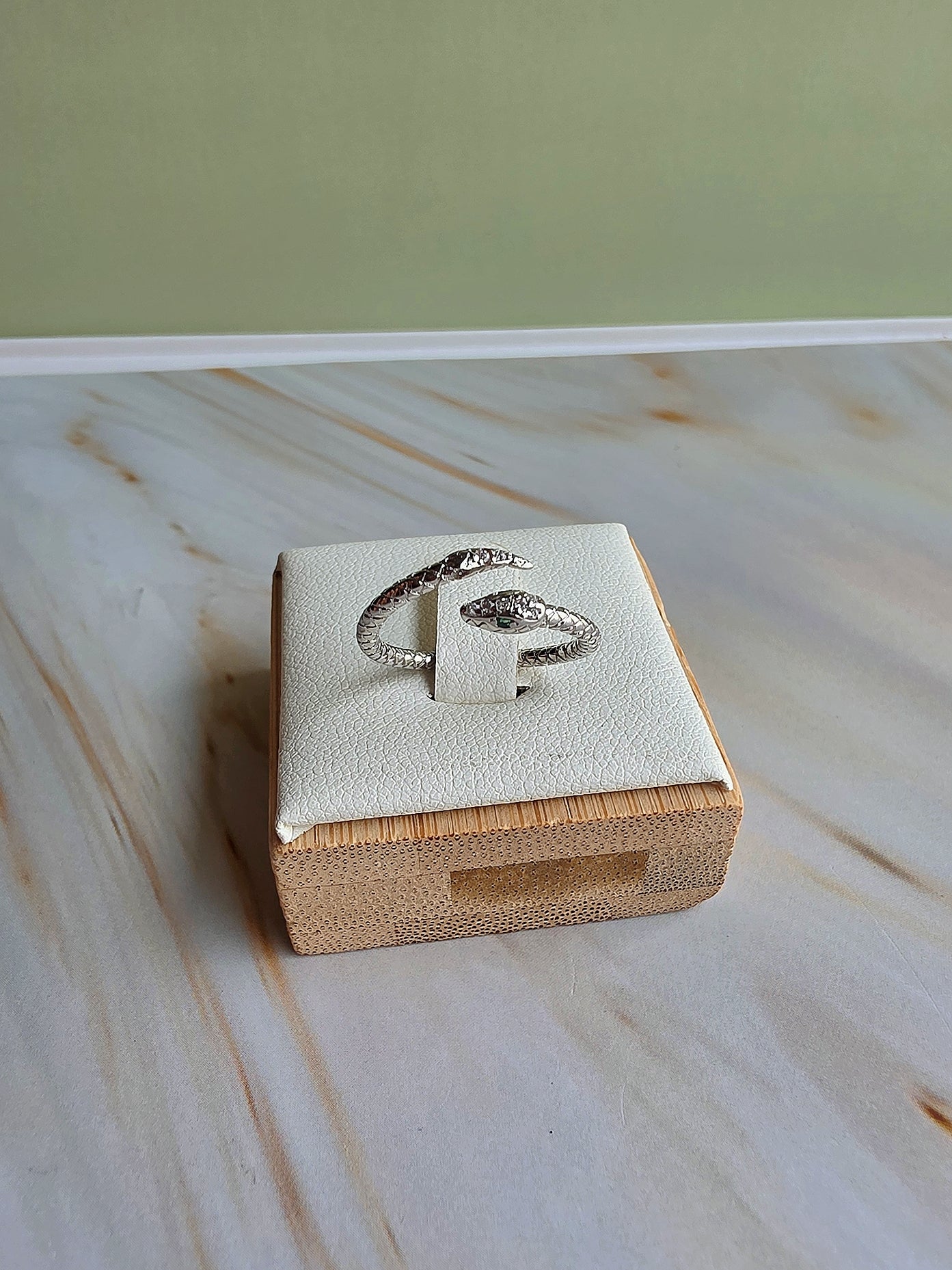 Women's adjustable serpent ring featuring a modern wrap-around design.