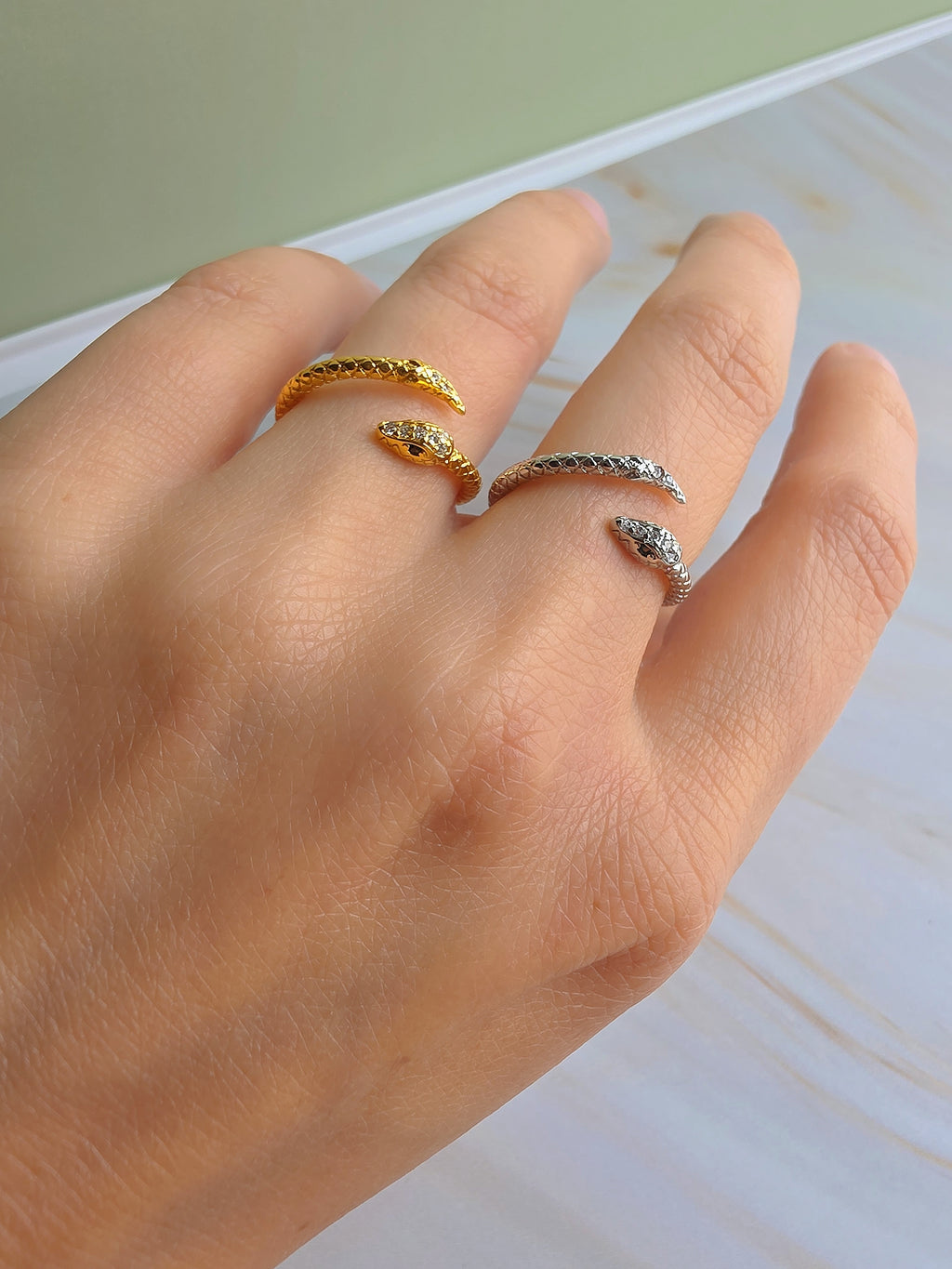 Dainty serpent ring available in gold and silver with a minimalist design.