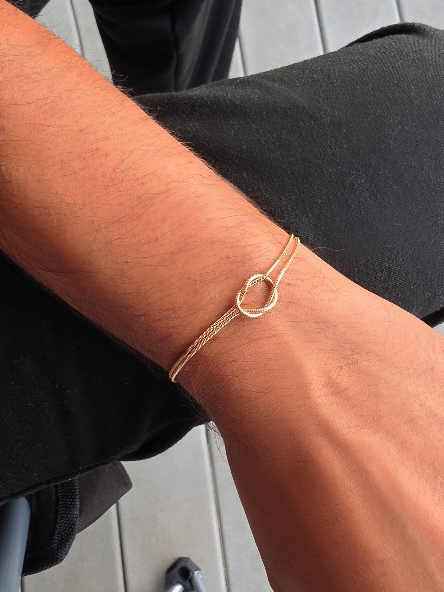 Adjustable non-tarnish love knot bracelets symbolizing love, connection, and commitment.