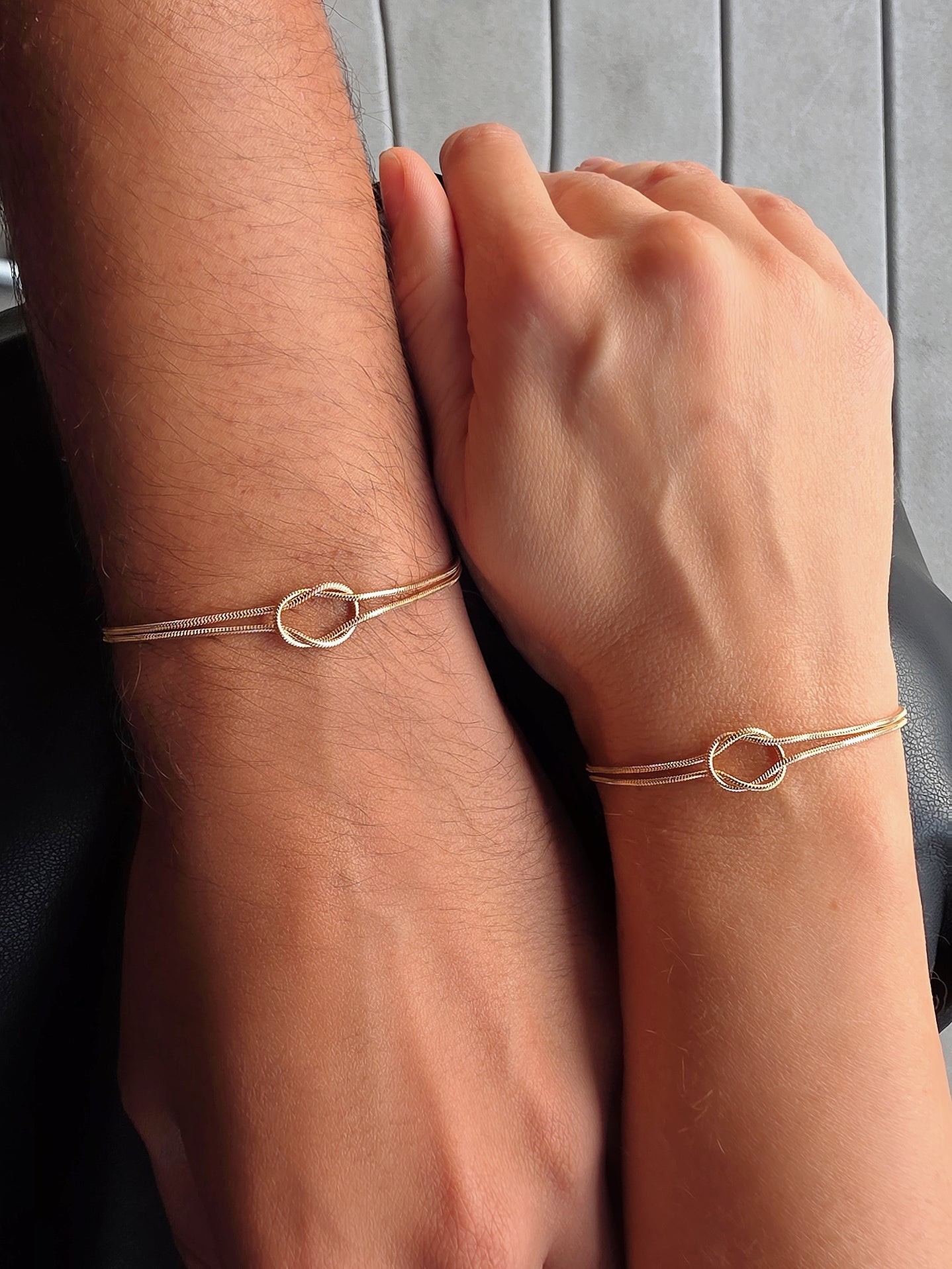 Dainty matching bracelets for couples with modern minimalist knot details.