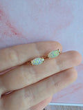 Elegant marquise-cut white opal huggie earrings in gold and silver finishes.