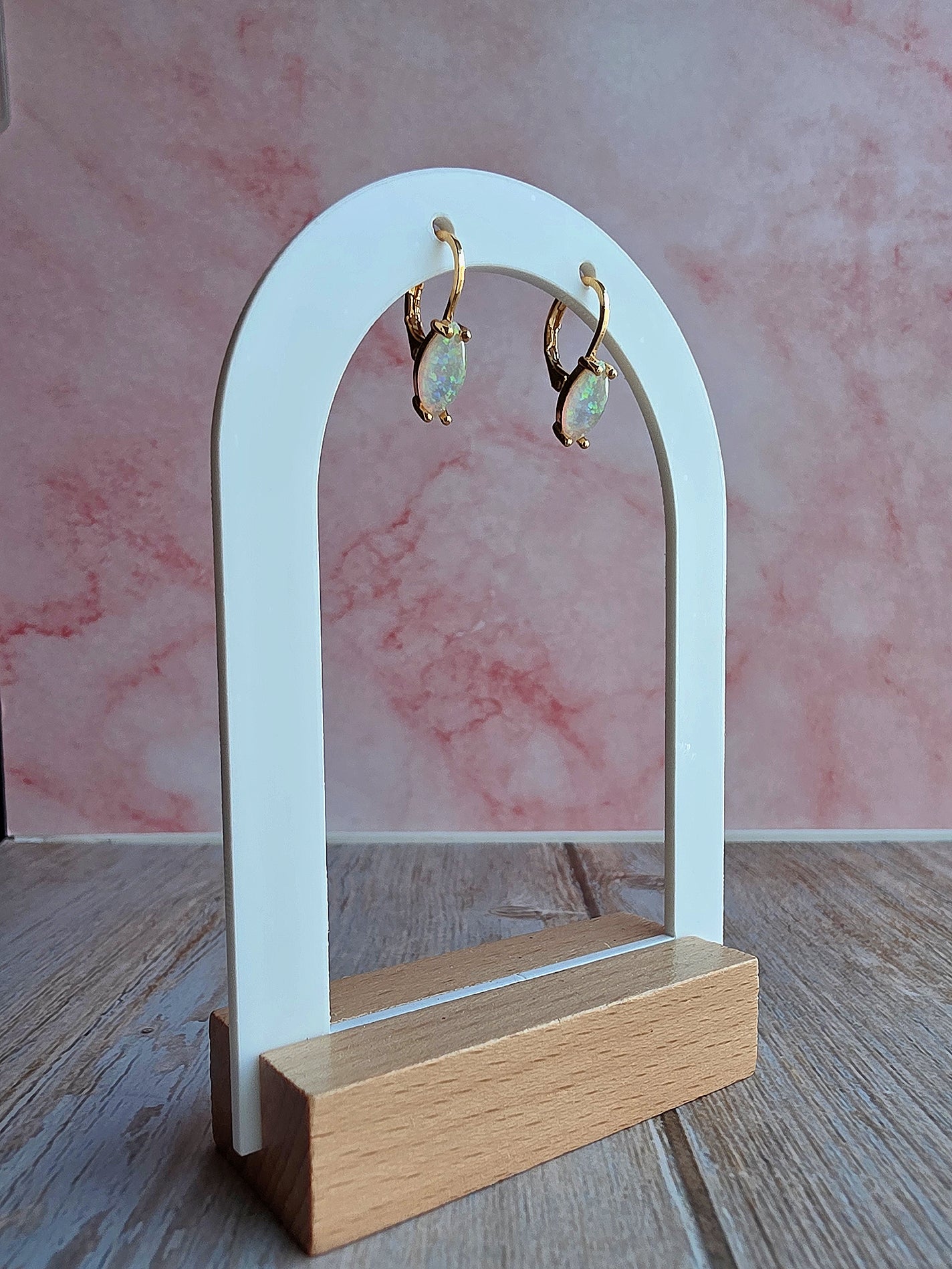 Minimalist October birthstone huggie earrings with marquise opal stones.
