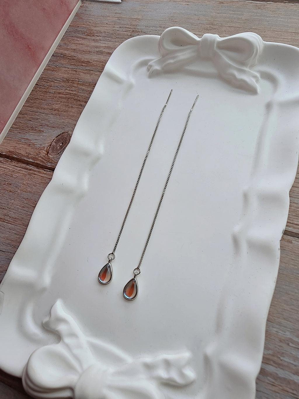 Delicate silver threader earrings with pear-shaped blue moonstone charms.
