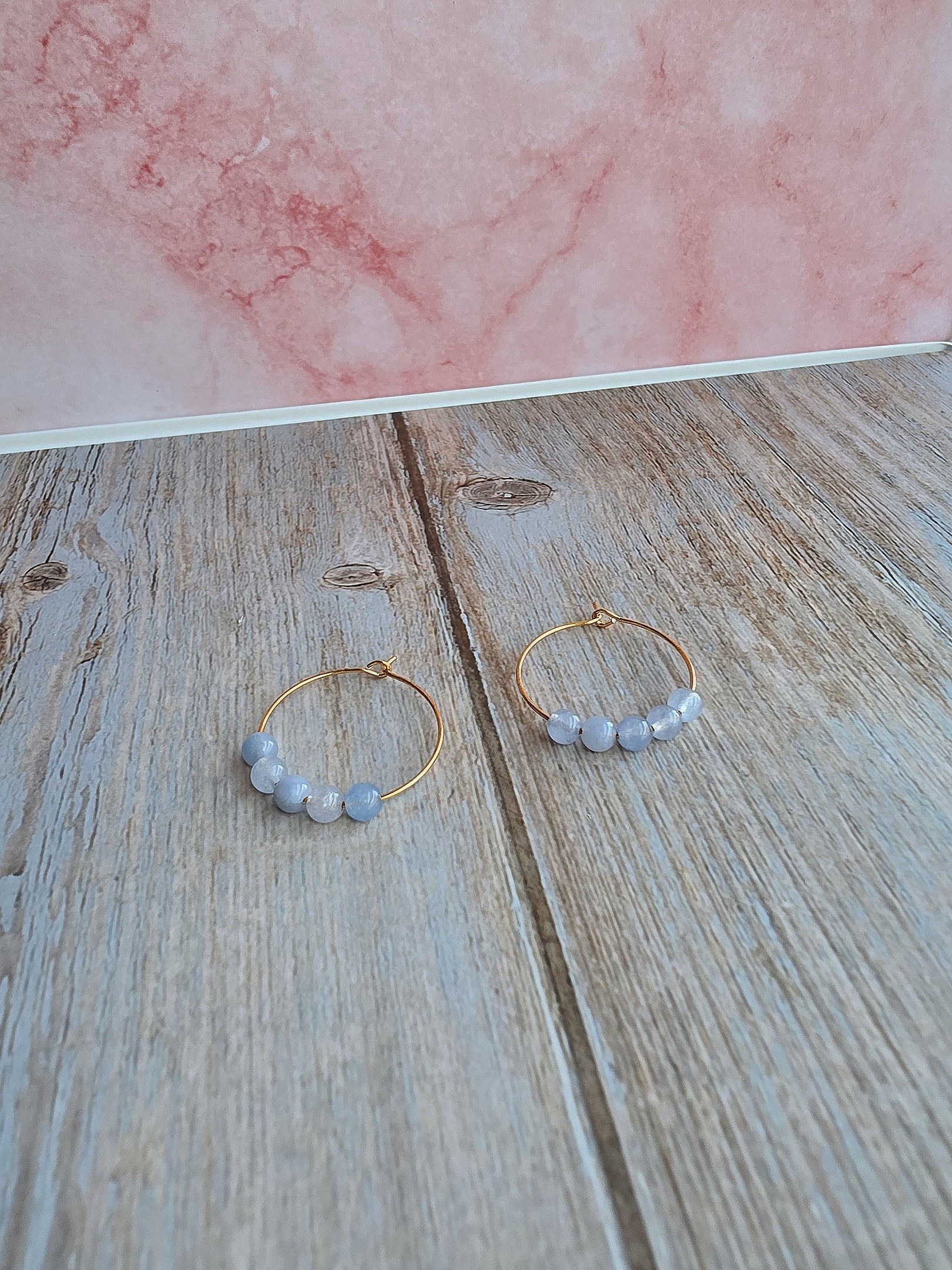 Delicate gold hoop earrings with natural aquamarine gemstone beads.