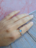 Adjustable 925 sterling silver ring with a luminous rainbow moonstone and gold plating.