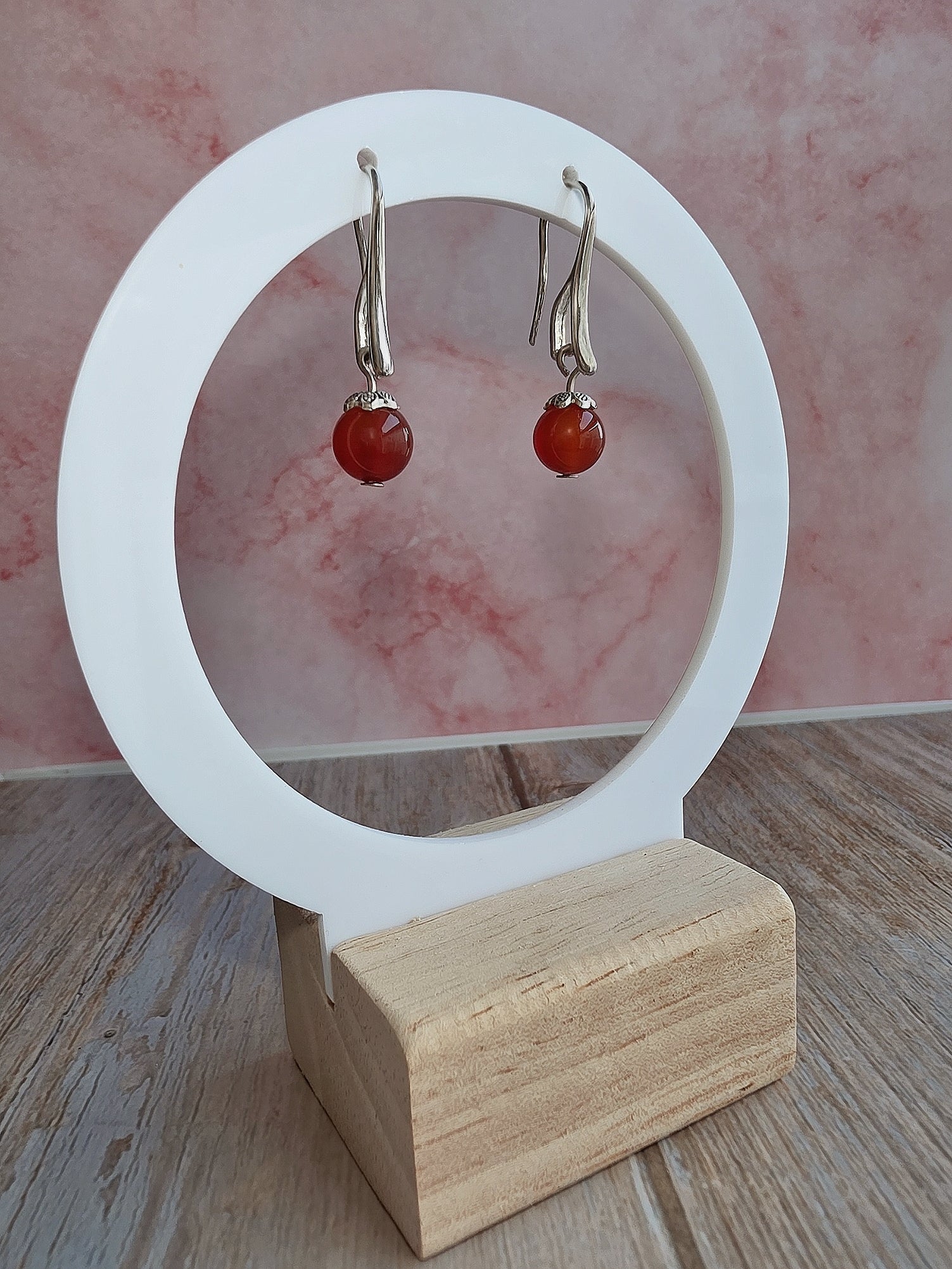 Elegant hook earrings with genuine gemstone beads in gold and silver settings.