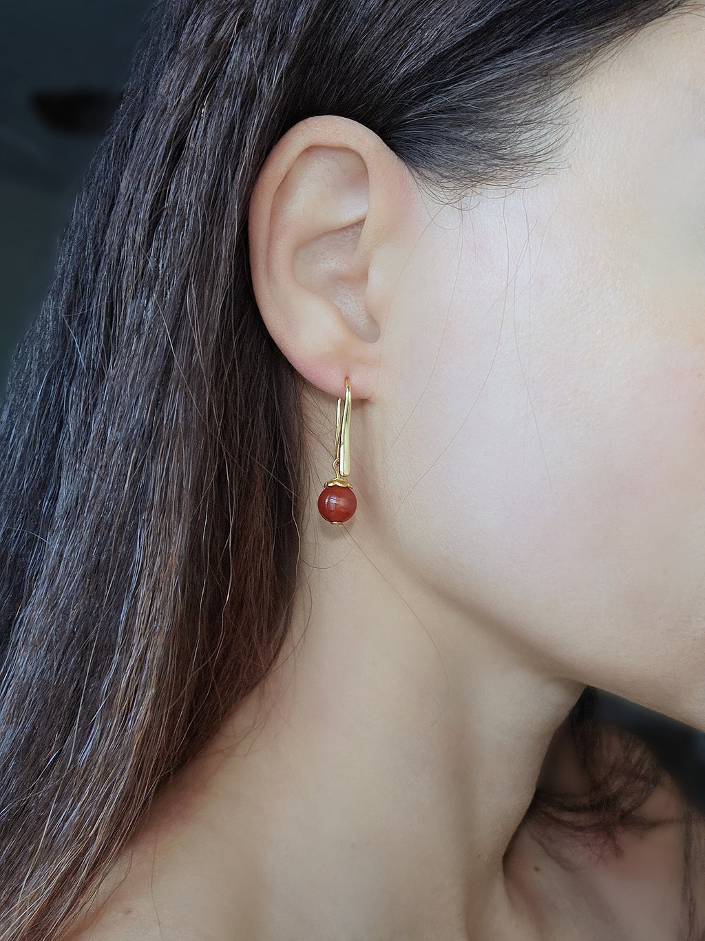 Silver and gold gemstone earrings with polished black onyx, blue lapis lazuli, and red agate beads.