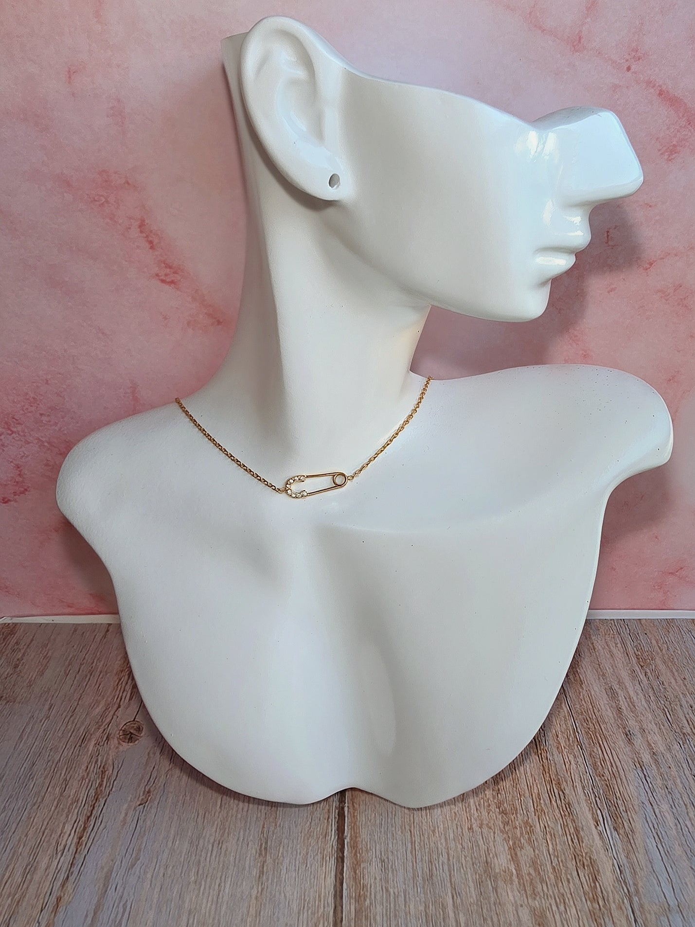 Gold-plated safety pin necklace with cubic zirconia accents for everyday wear.