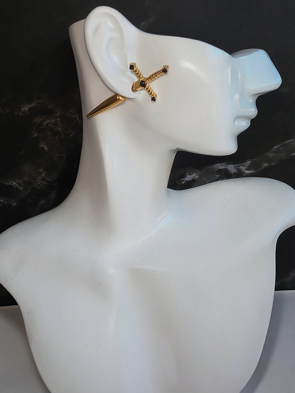 Minimalist dagger stud earrings with a sleek gold-plated finish.