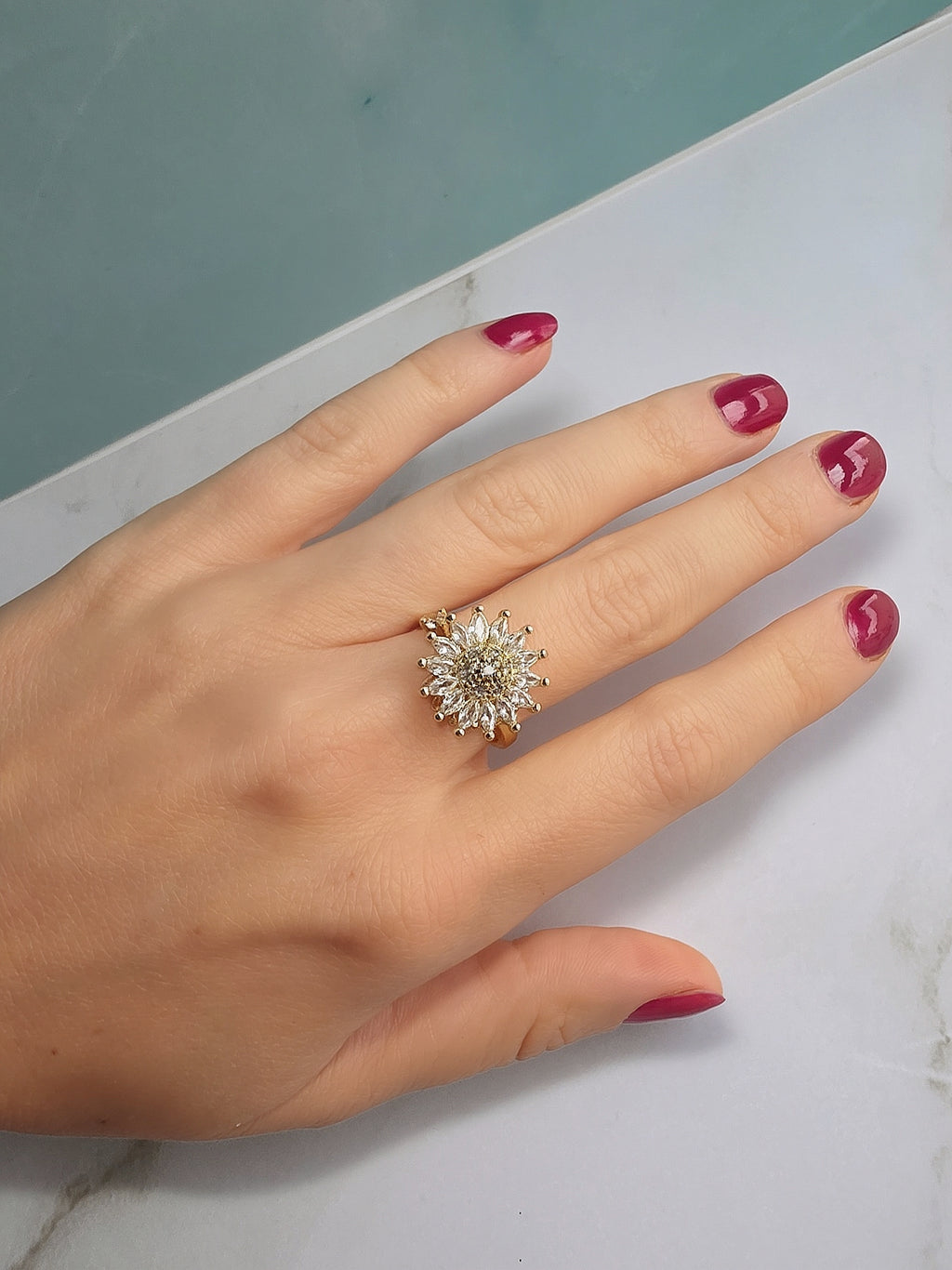 14K gold-plated flower fidget ring with a smooth spinning centerpiece.
