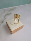 Women's flower spinner ring featuring an elegant adjustable open band.