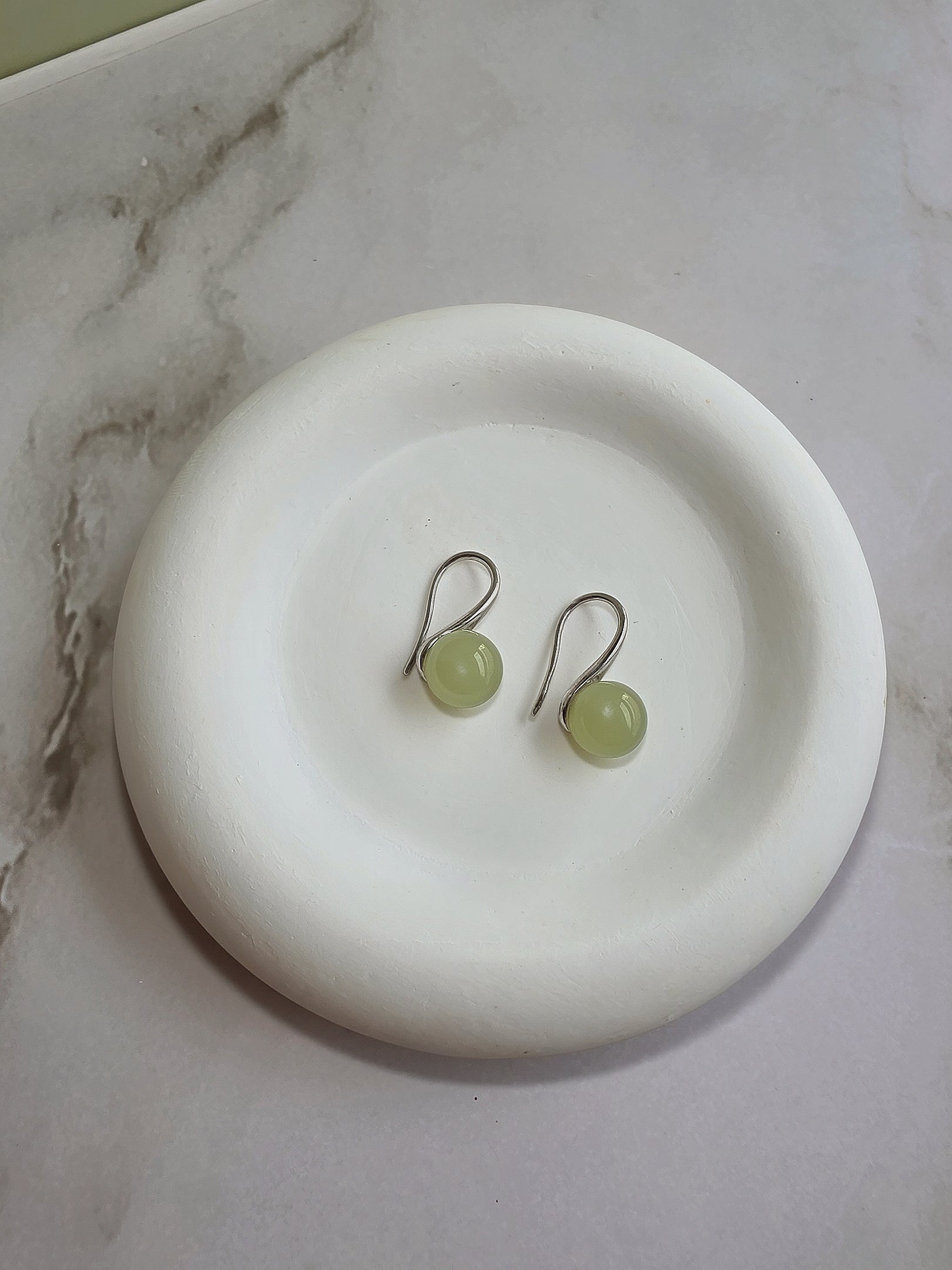 Dainty green gemstone earrings crafted with genuine jade and 14K gold plating.