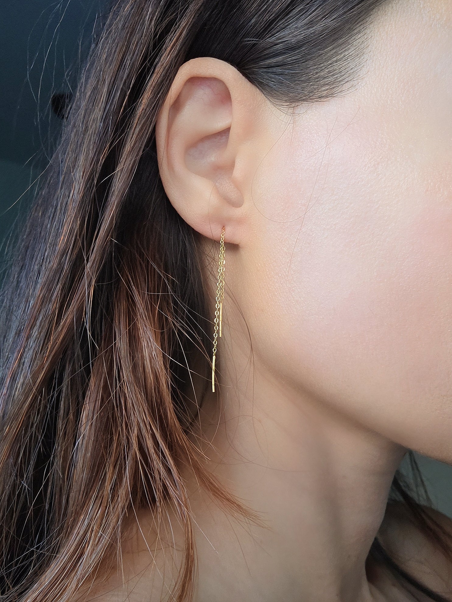 Dainty threader earrings featuring a sleek chain and bar design.