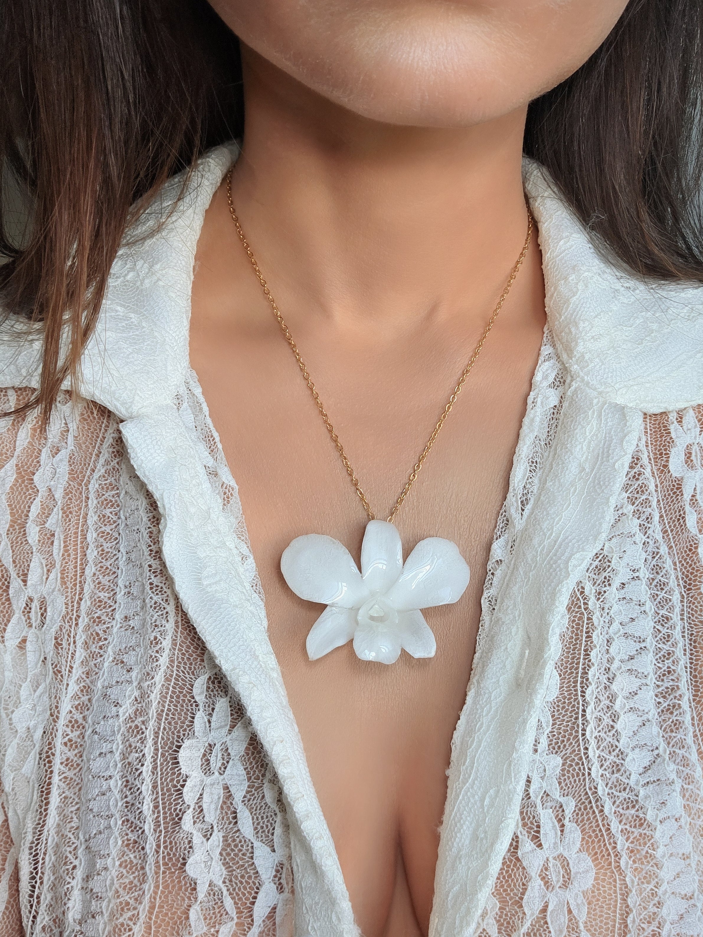 Elegant preserved orchid flower necklace with a real botanical pendant and gold-plated chain.