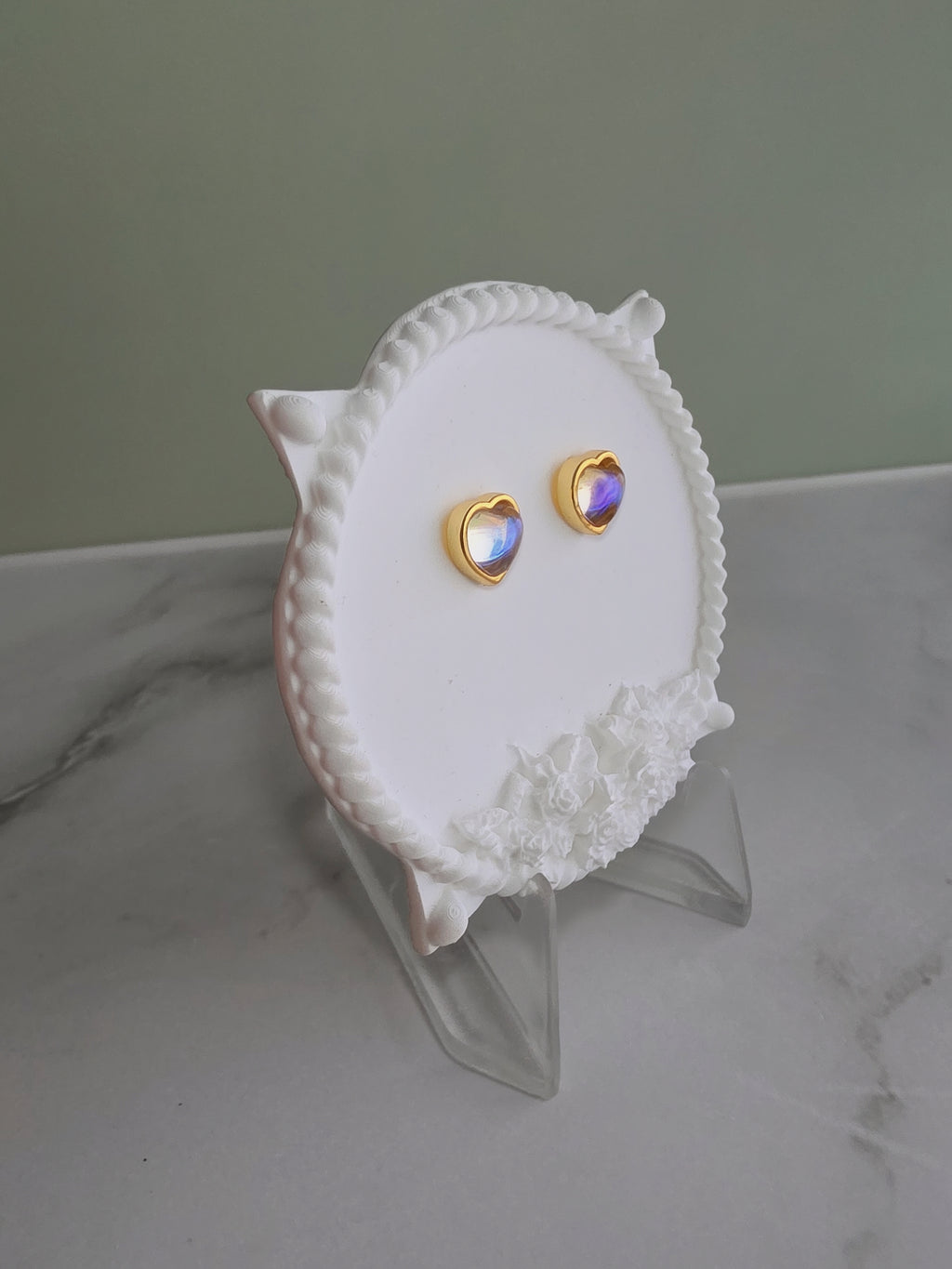 Gold heart earrings inspired by the June birthstone.