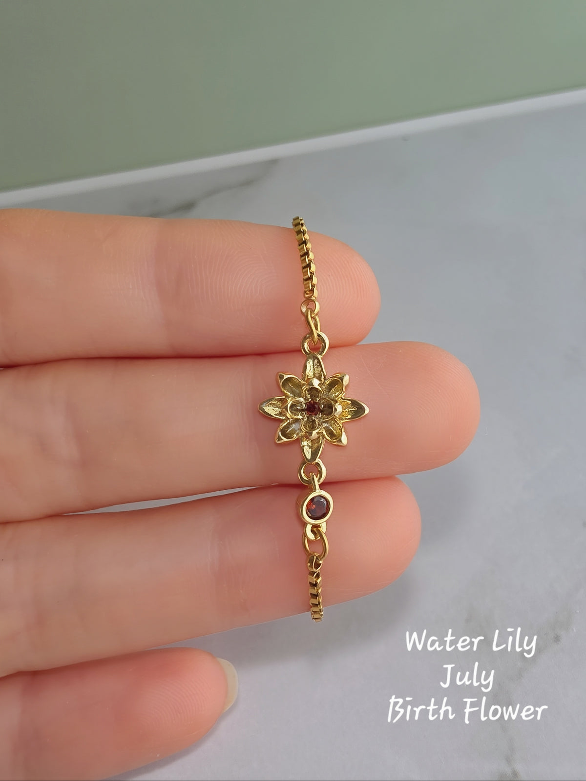 Birthstone bracelet with an engraved birth flower charm for women.