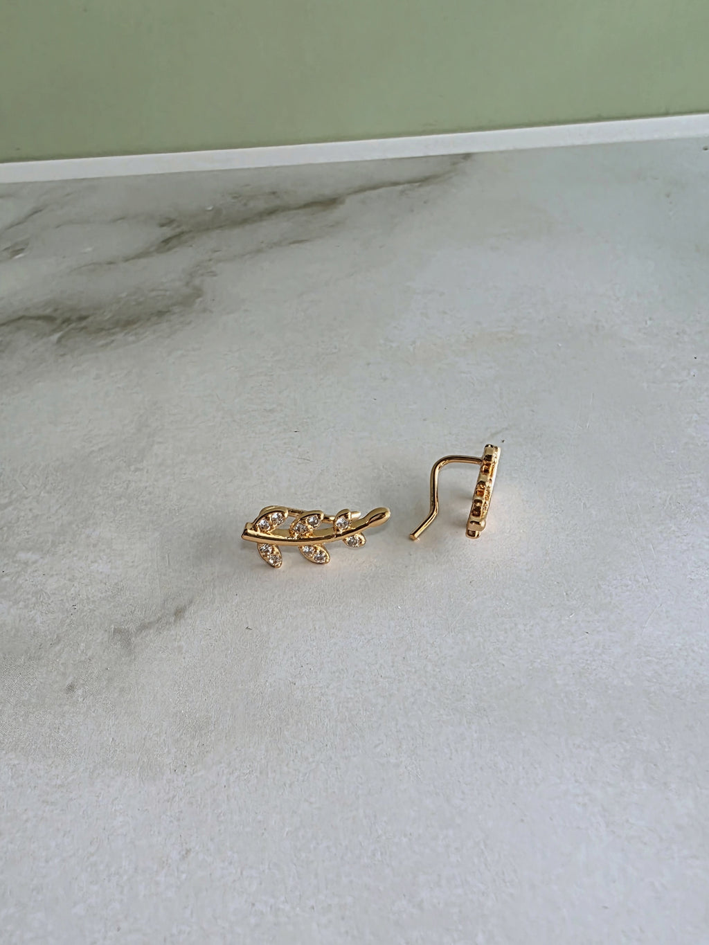 Elegant botanical ear climber earrings inspired by leaves and flowers.