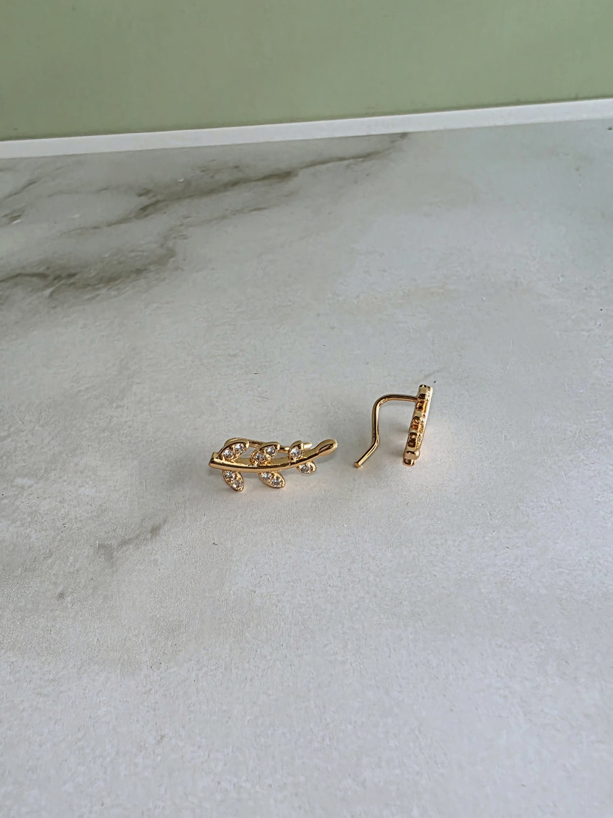 Elegant botanical ear climber earrings inspired by leaves and flowers.