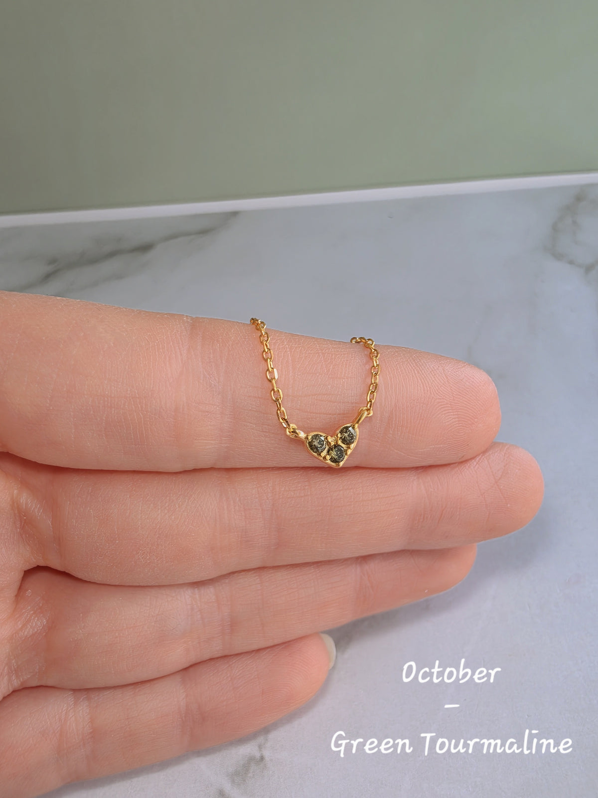 Elegant heart necklace featuring a sparkling birthstone on an 18K gold-plated sterling silver chain.