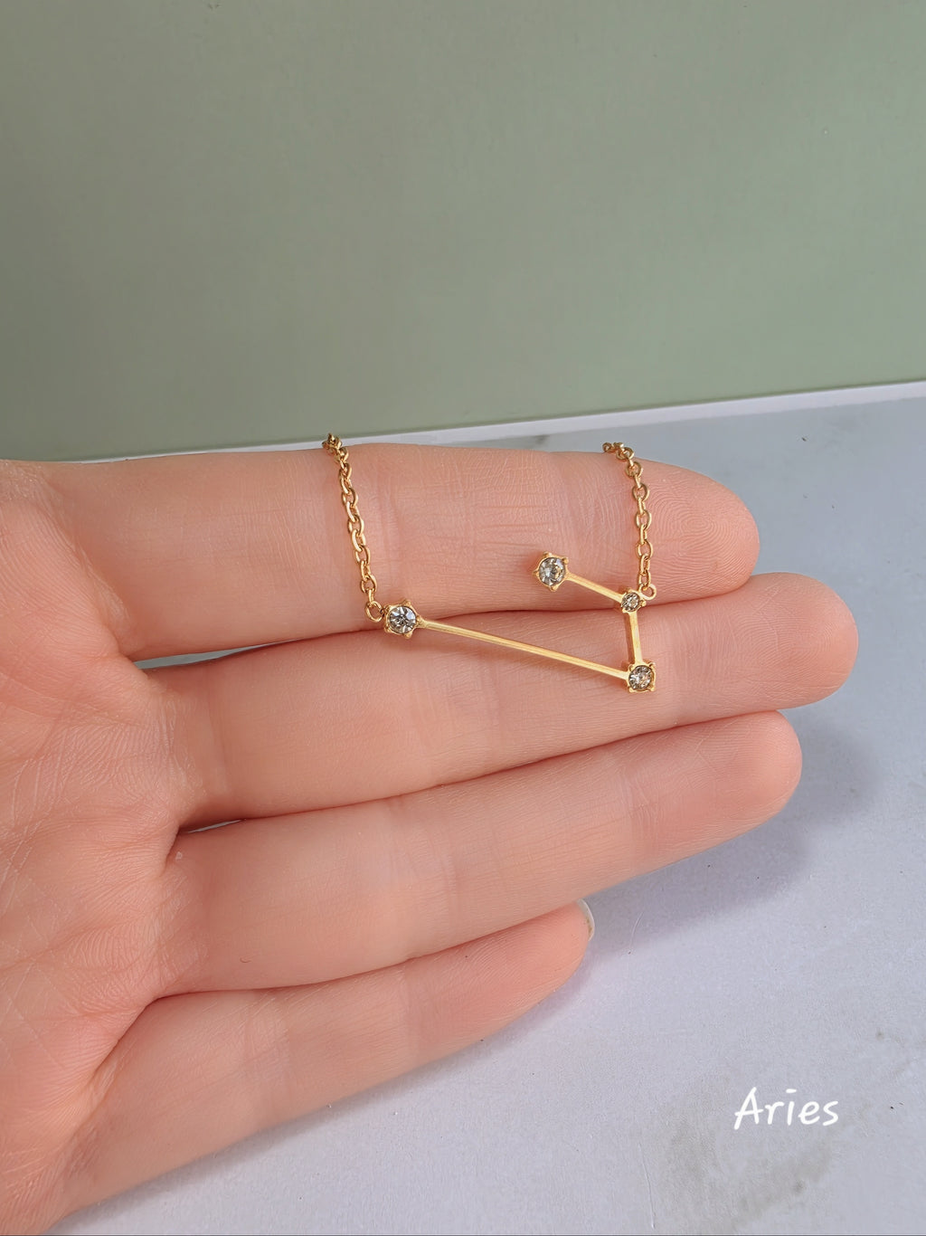 18K gold-plated zodiac constellation necklace with sparkling celestial details.