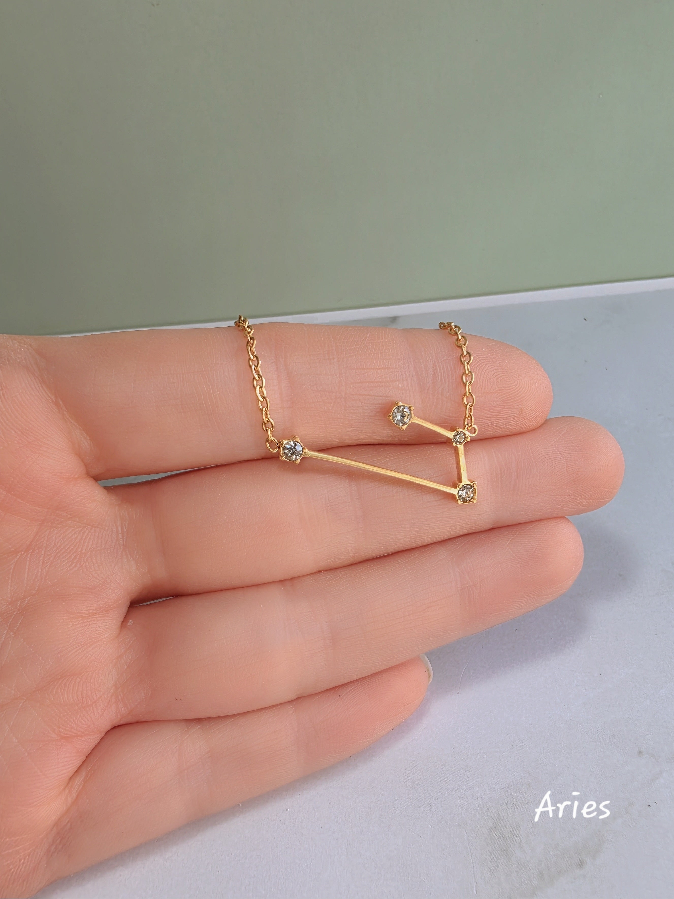 18K gold-plated zodiac constellation necklace with sparkling celestial details.