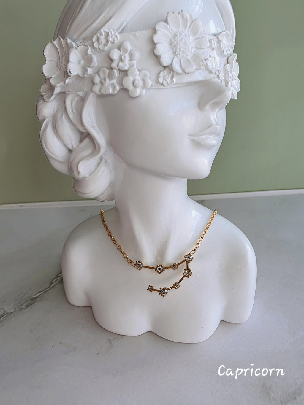 Gold zodiac necklace with sparkling constellation details.