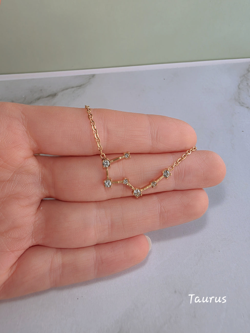 18K gold-plated zodiac constellation necklace with sparkling celestial details.