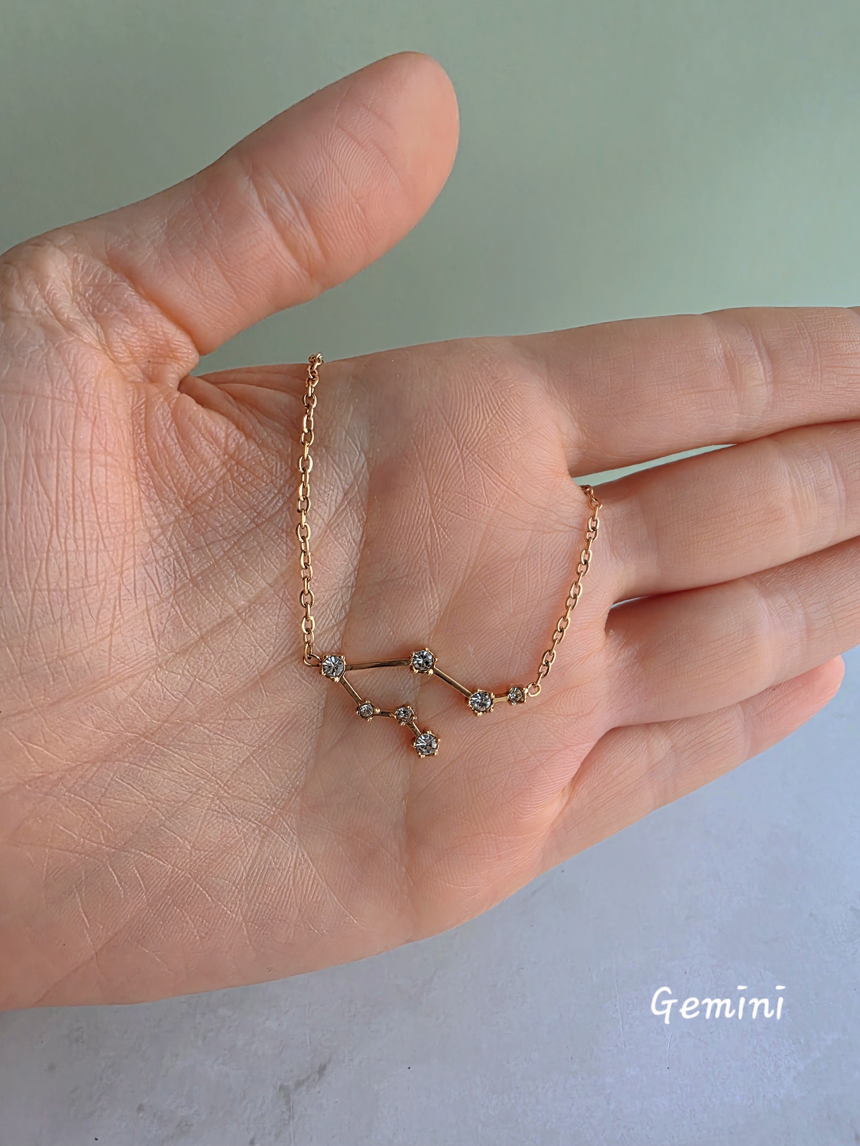Celestial astrology necklace featuring a zodiac constellation pendant.