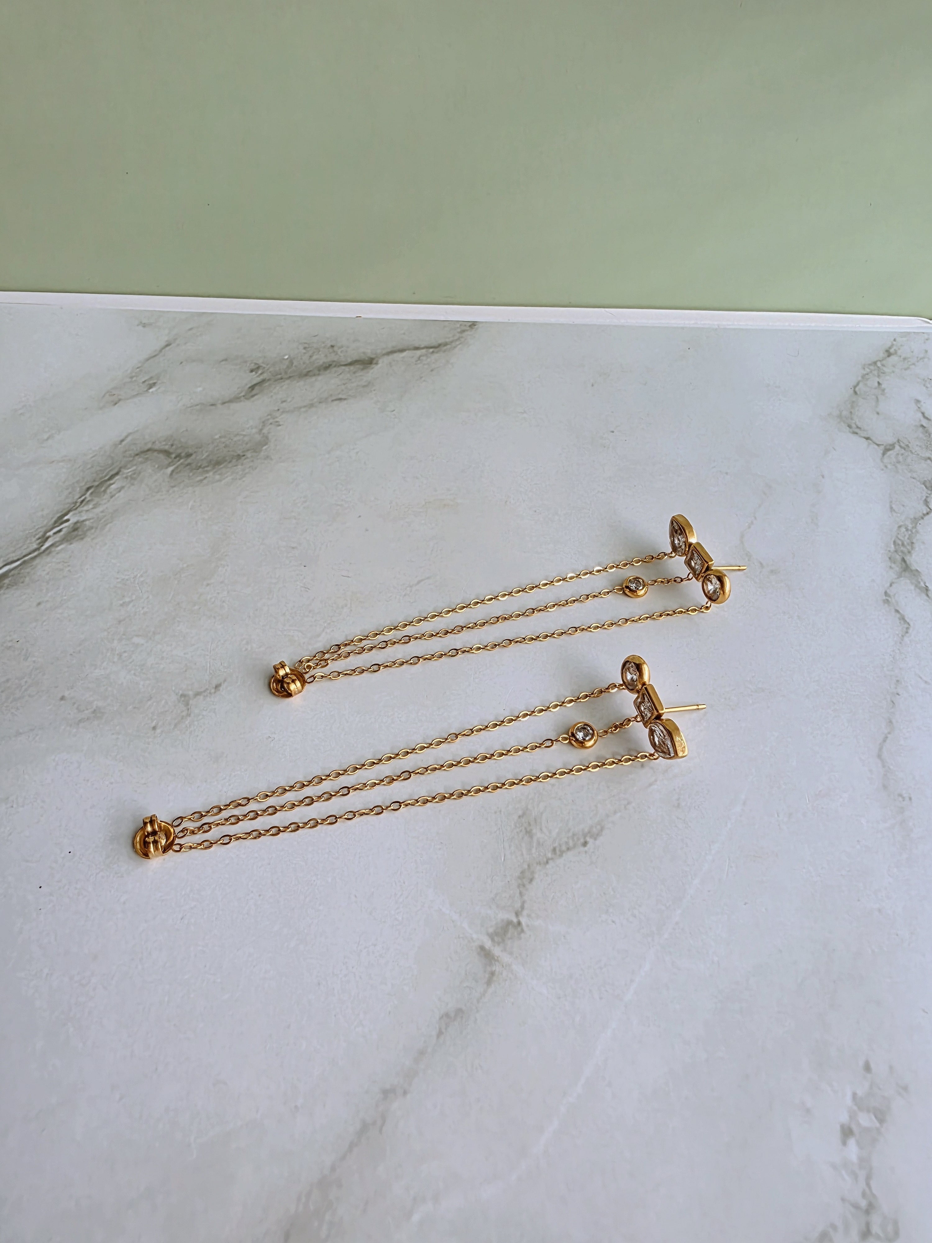 Modern chain drop earrings with an 18K gold-plated stainless steel base and sterling silver posts.