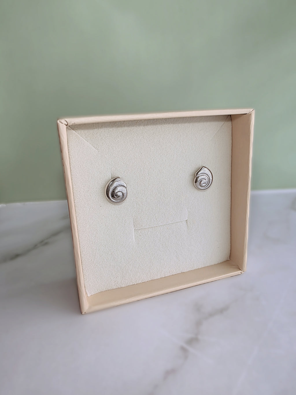 Minimalist spiral stud earrings with a contemporary look.