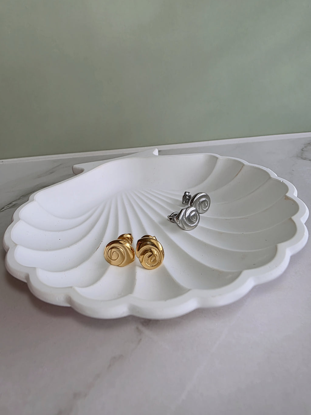 Elegant spiral earrings inspired by the graceful shape of a snail shell.