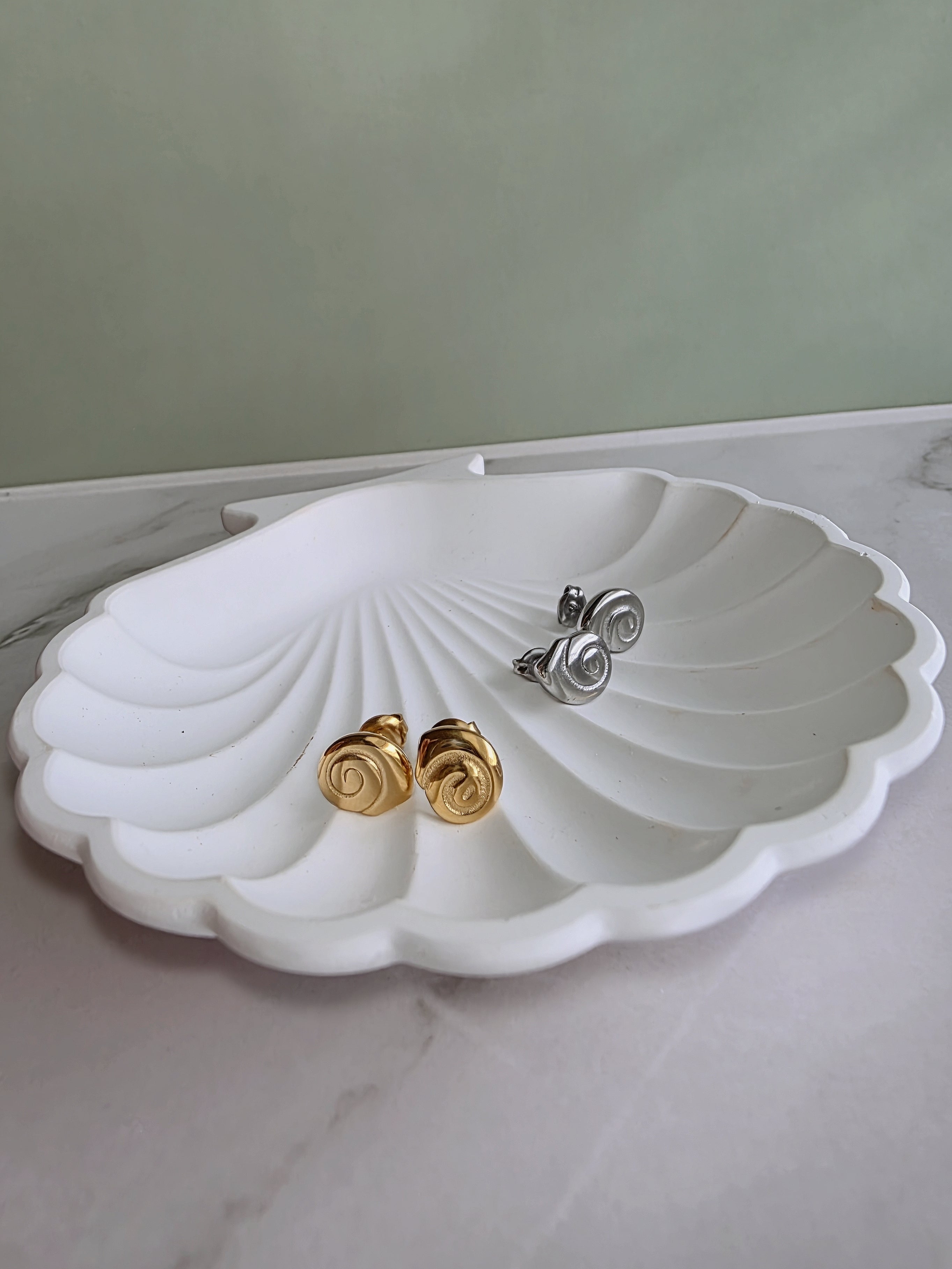 Elegant spiral earrings inspired by the graceful shape of a snail shell.