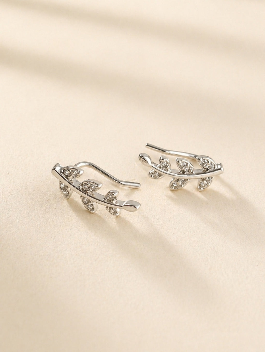 Gold floral vine ear crawler earrings with cubic zirconia accents.