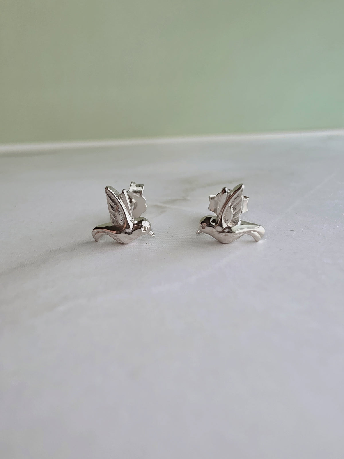 Detailed hummingbird stud earrings in sterling silver.