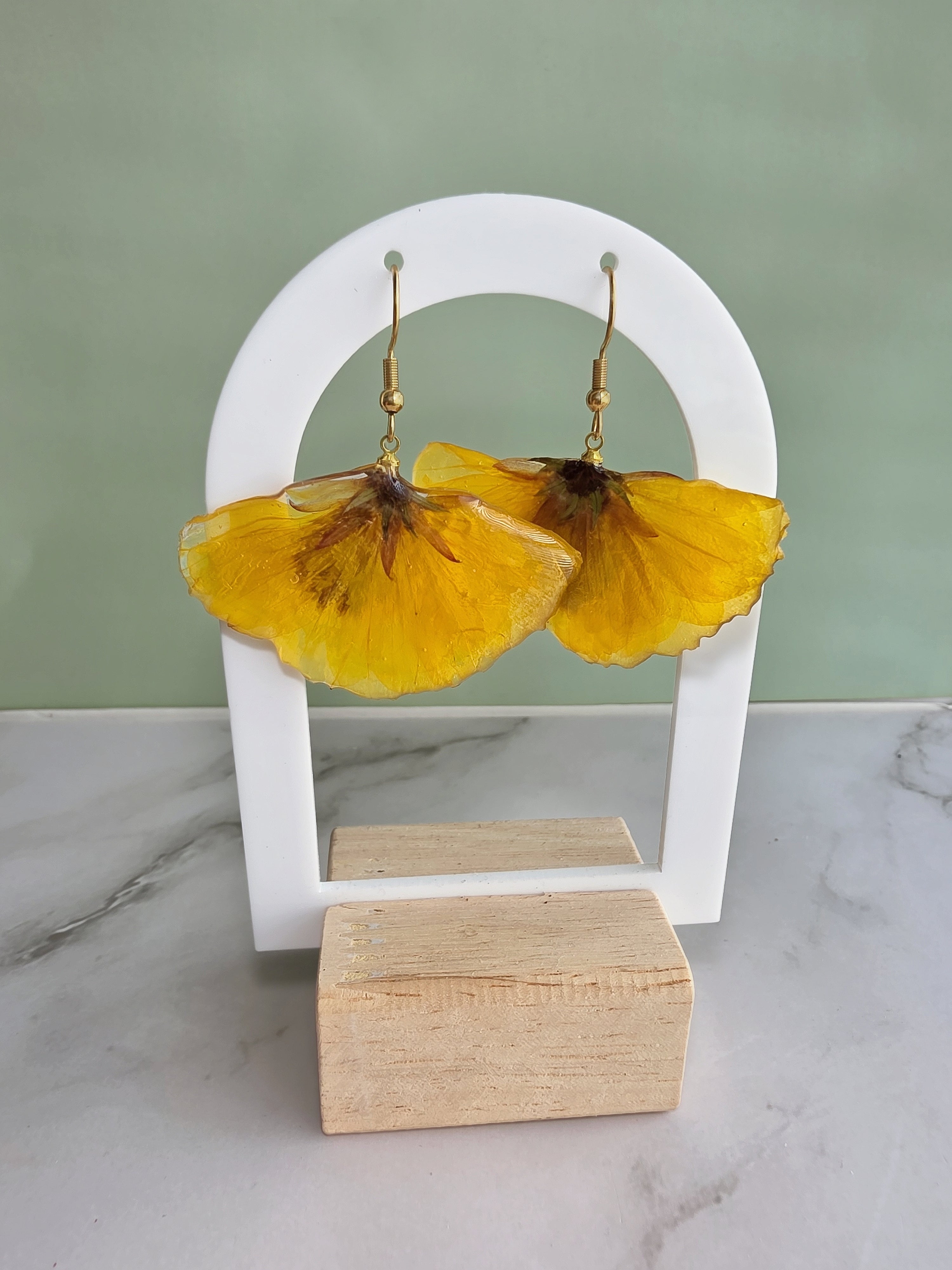 Handcrafted botanical earrings featuring genuine preserved flowers.