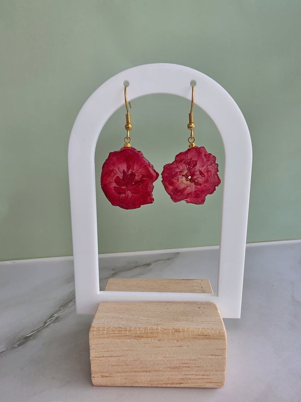 Pink cherry blossom pressed flower earrings with 14K gold-plated hooks.