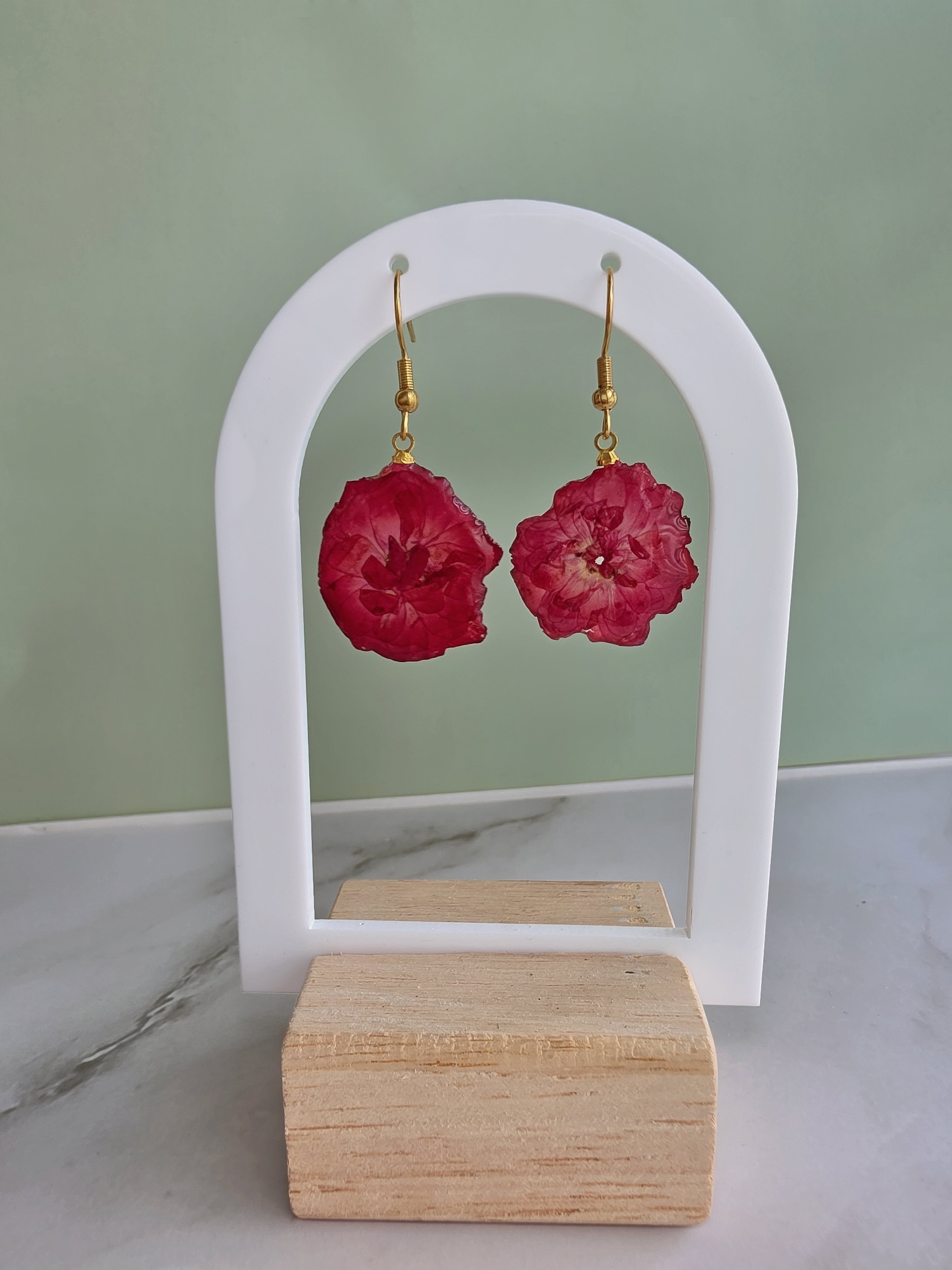 Pink cherry blossom pressed flower earrings with 14K gold-plated hooks.