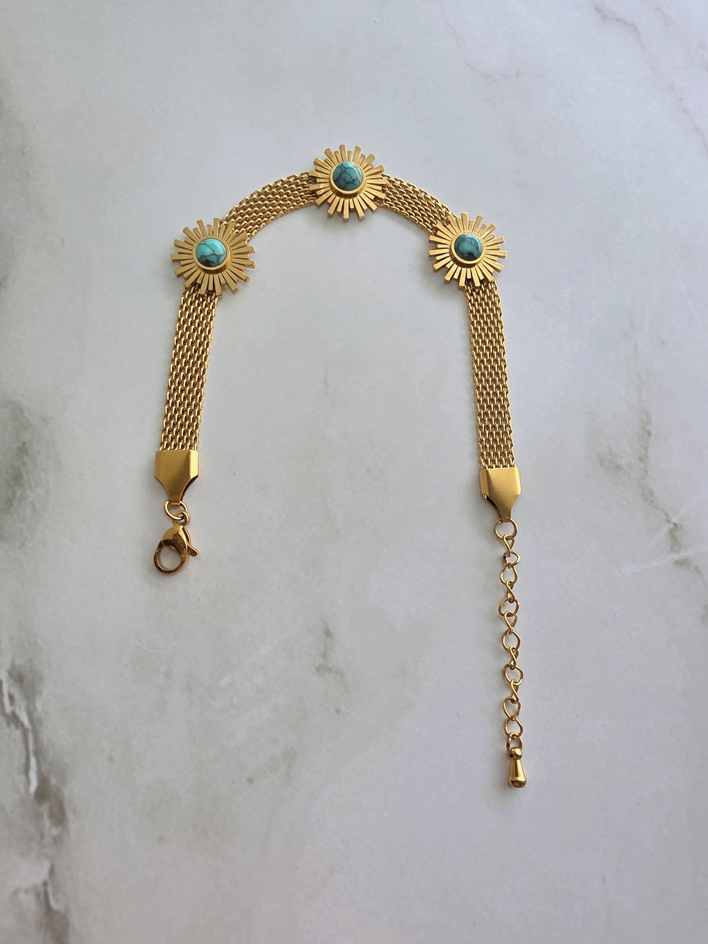 18K gold-plated sunflower bracelet with a turquoise-colored stone.