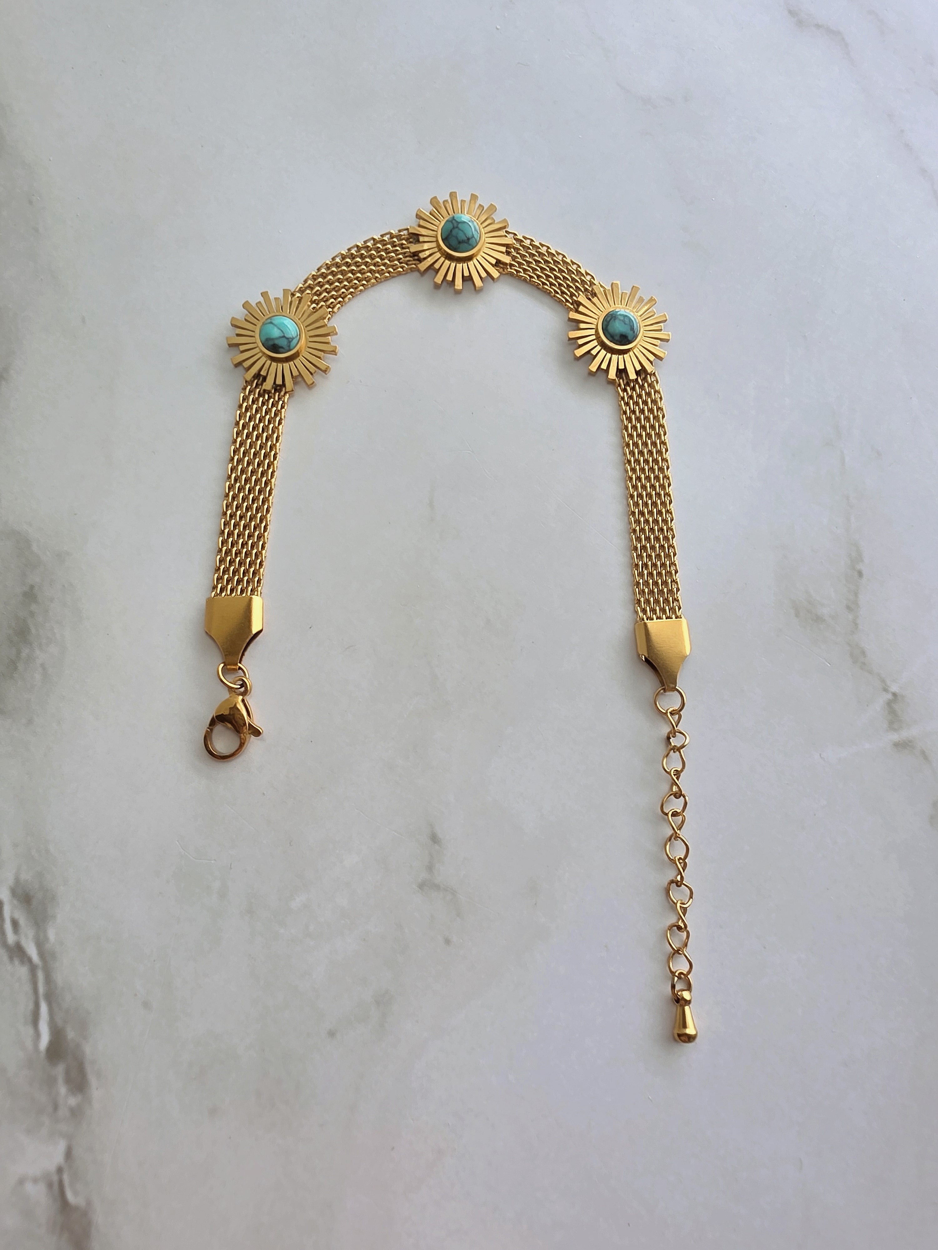 18K gold-plated sunflower bracelet with a turquoise-colored stone.