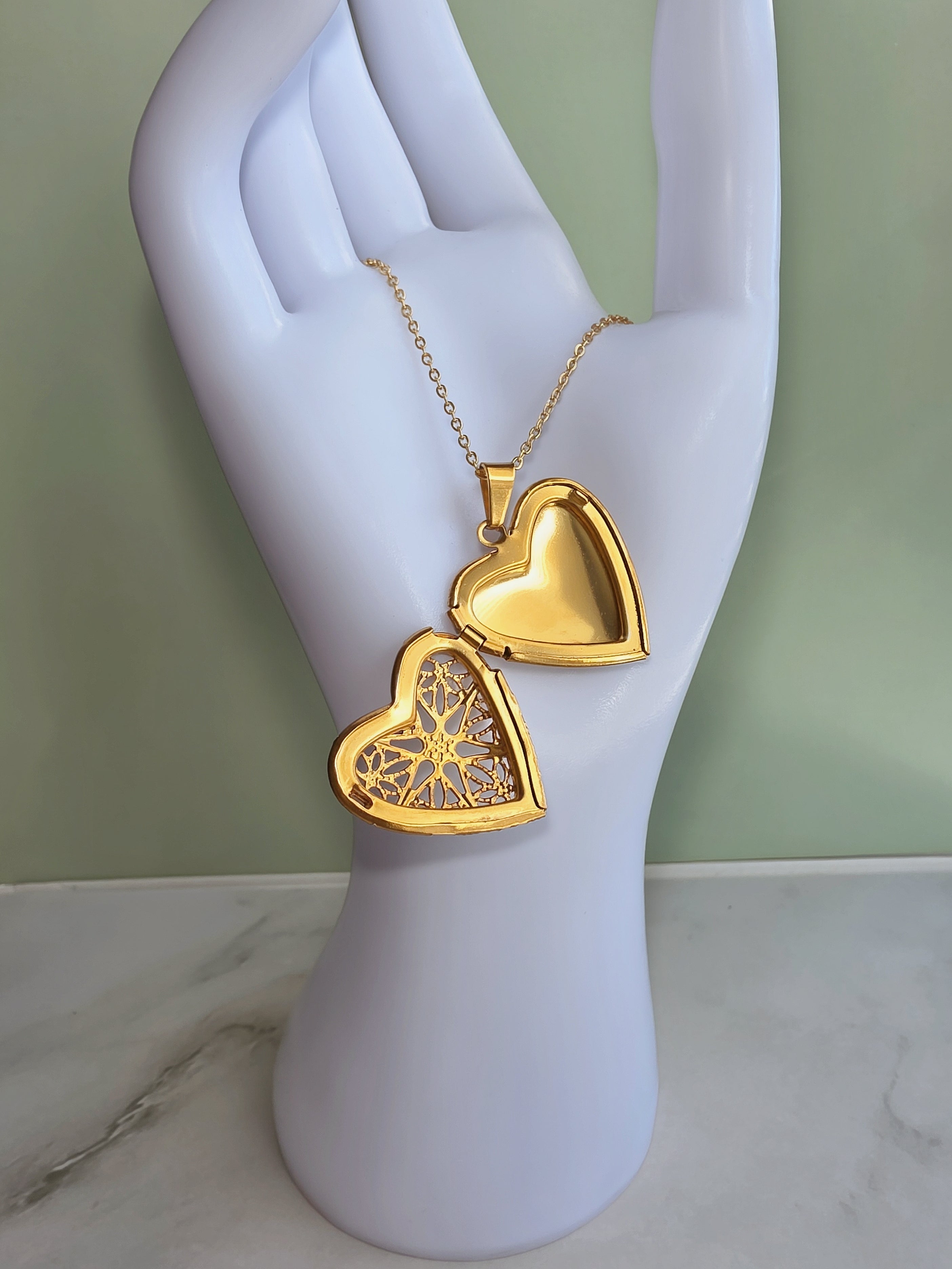 Heart-shaped locket necklace available in gold and silver finishes.