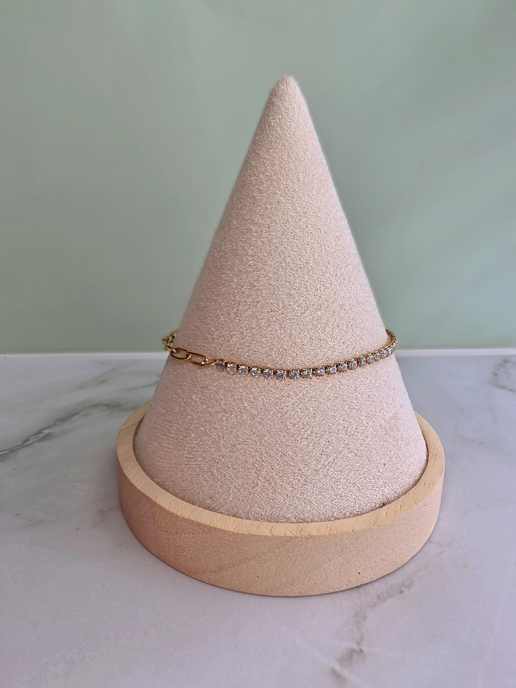 Elegant paperclip chain anklet with a CZ tennis detail and polished gold finish.