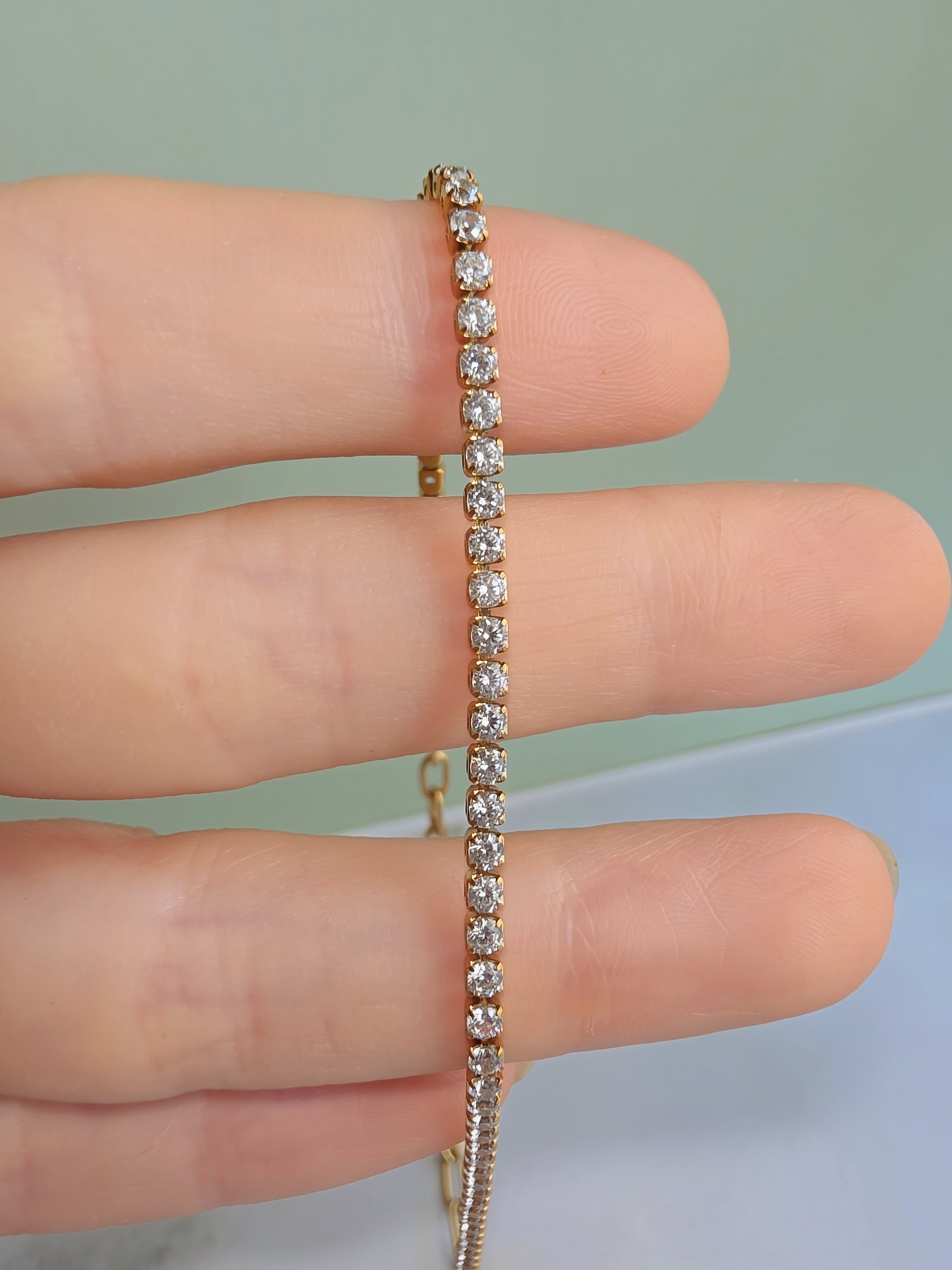 Layered paperclip and tennis chain necklace with an elegant 18K gold-plated finish.