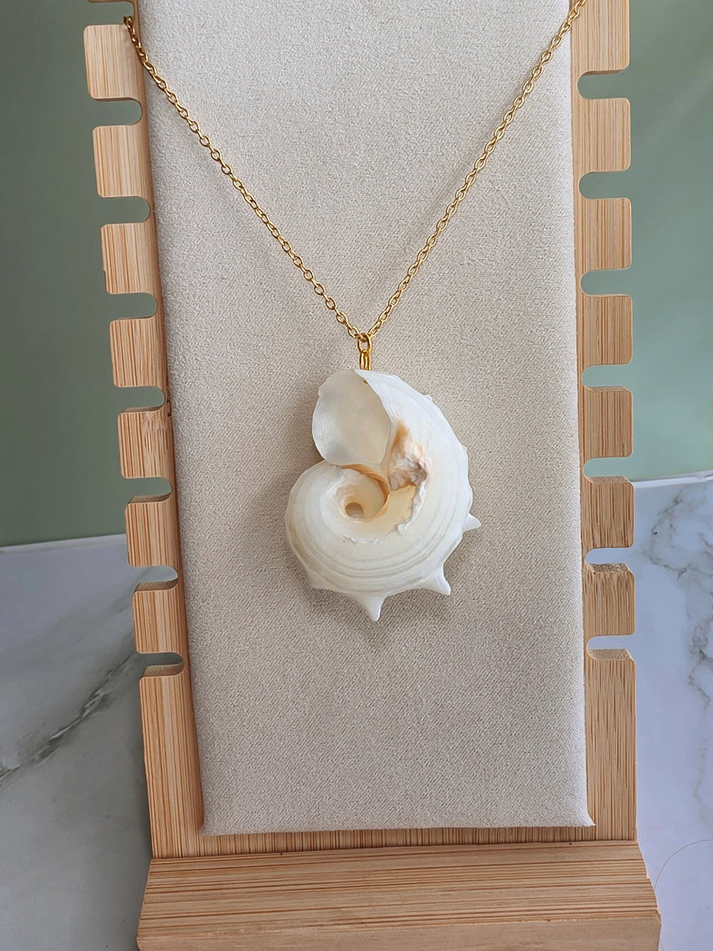 Natural seashell necklace featuring a polished 18K gold-plated pendant.