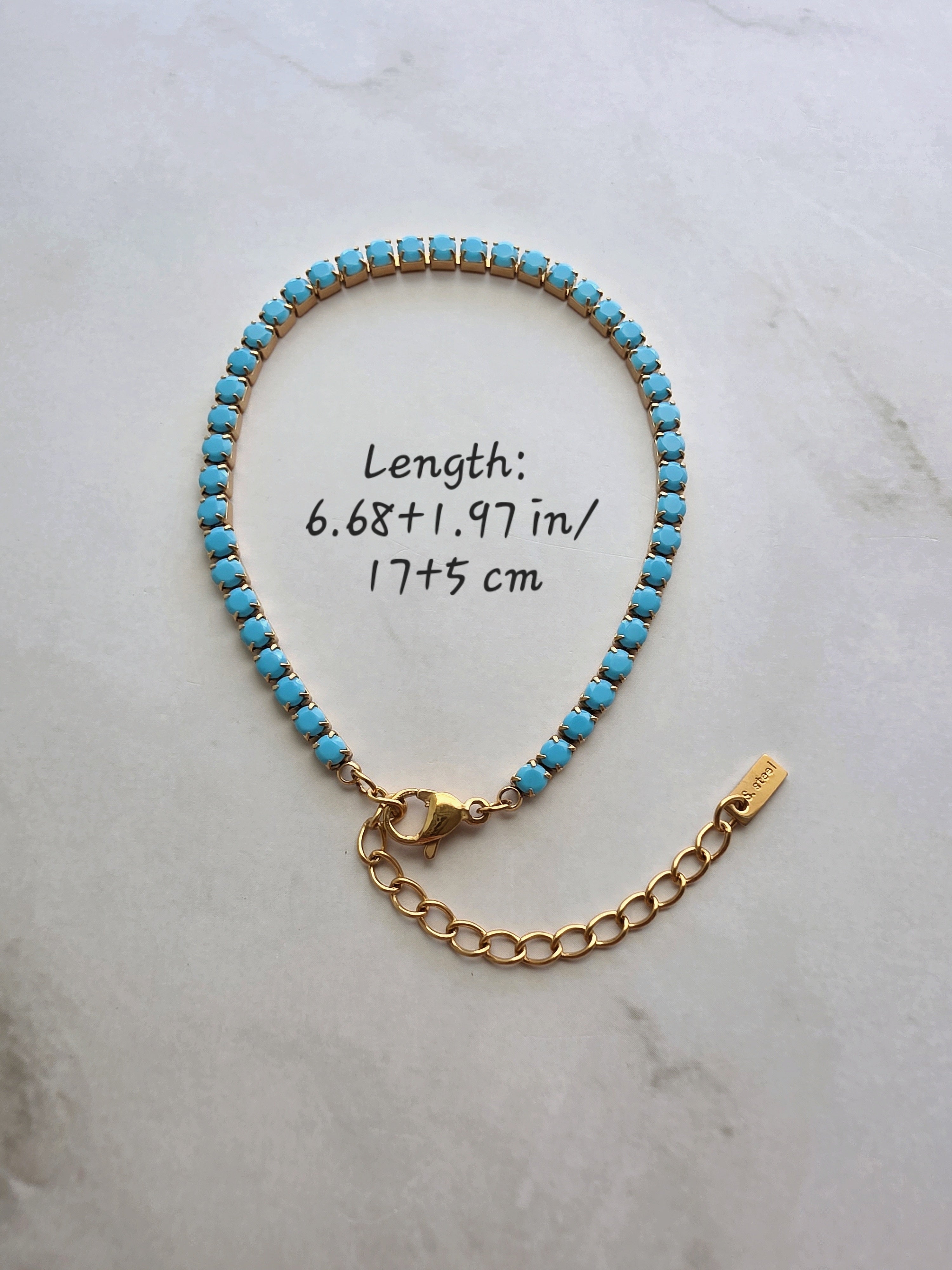 18K gold-plated bracelet featuring a row of turquoise-colored stones.