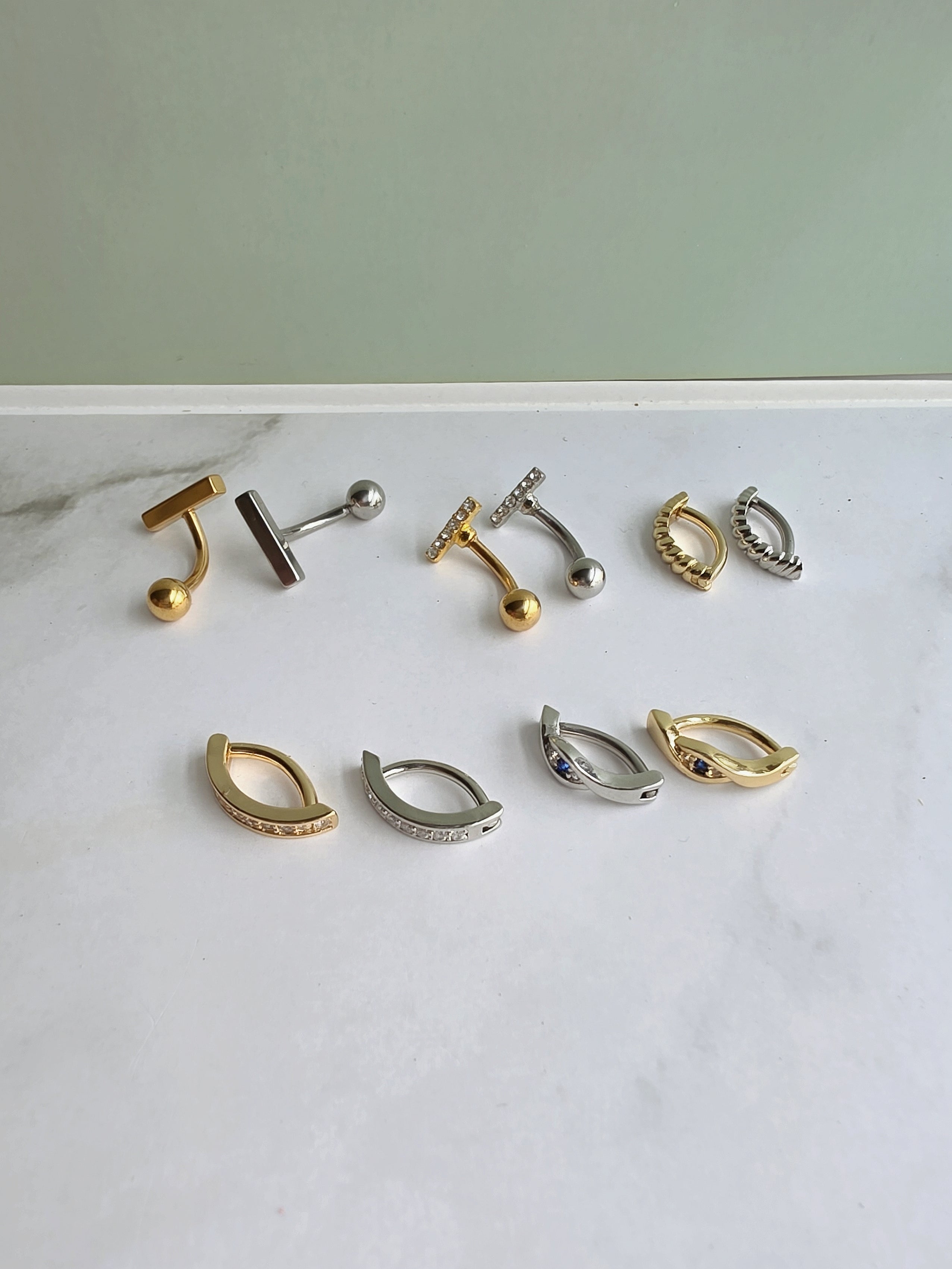 Gold belly button rings with 316L surgical steel posts.