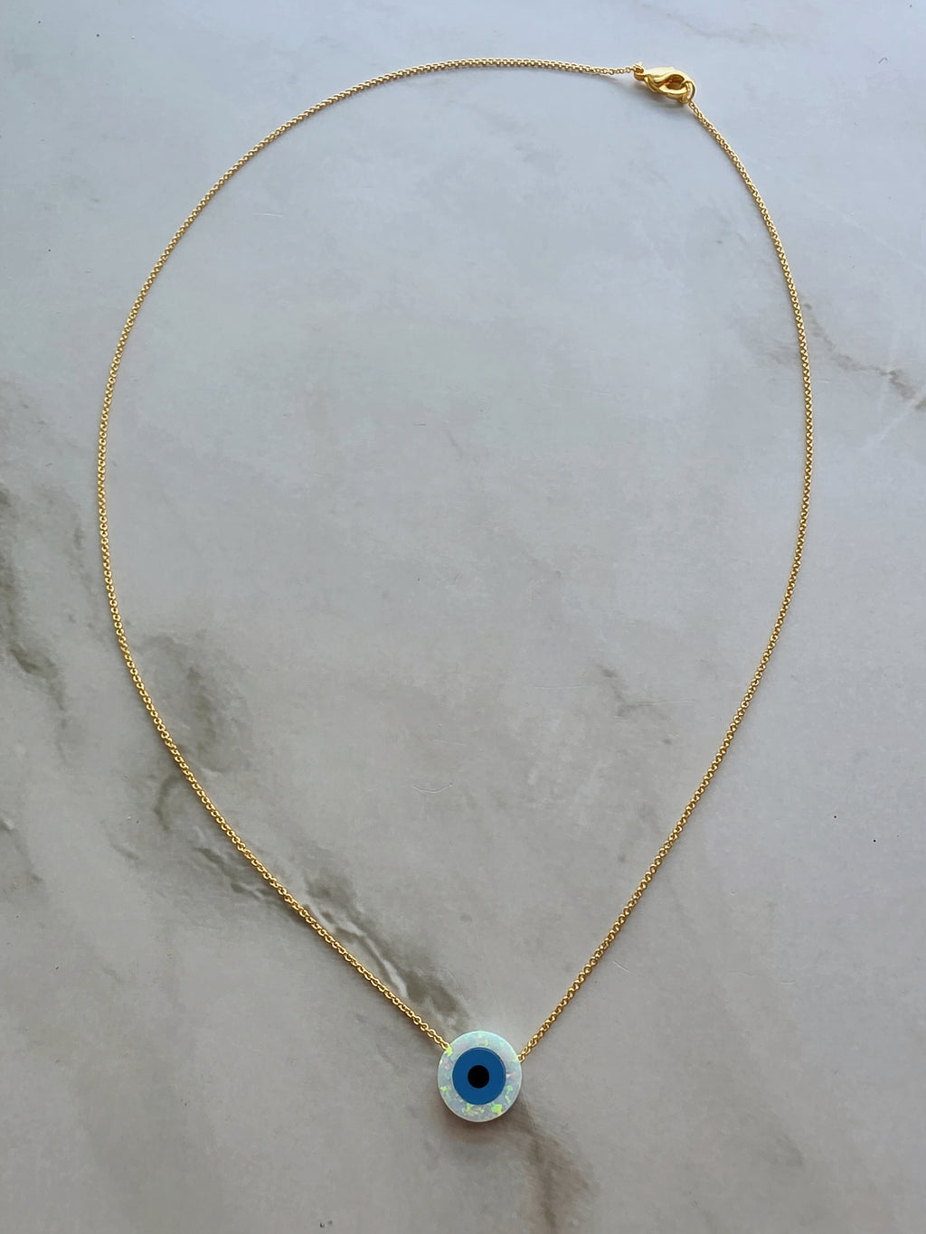 Silver necklace with an evil eye opal pendant for everyday wear.