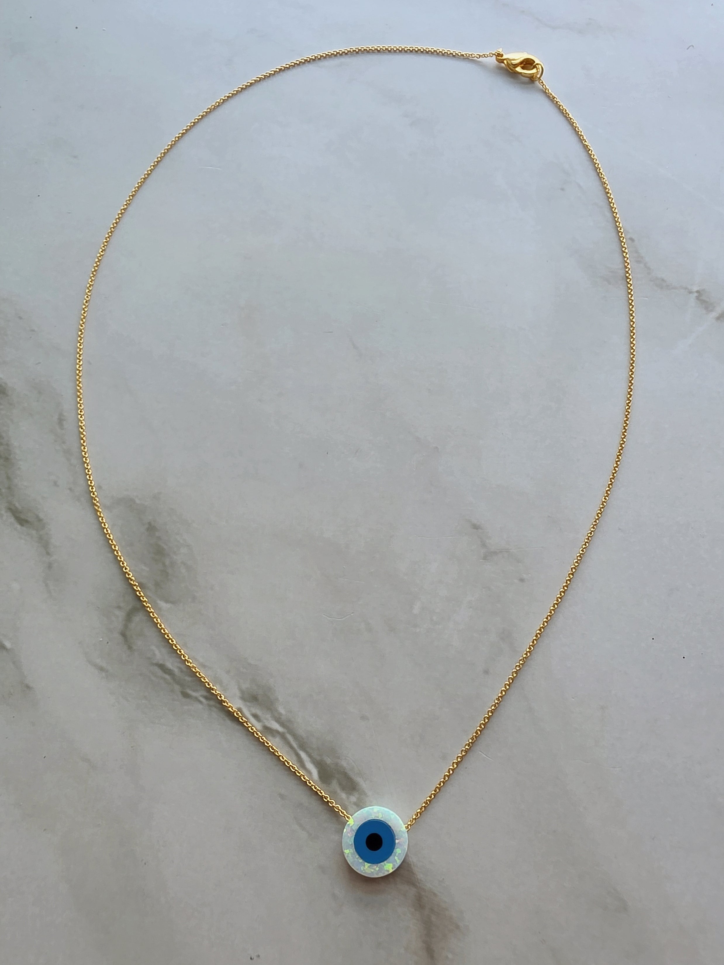 Silver necklace with an evil eye opal pendant for everyday wear.