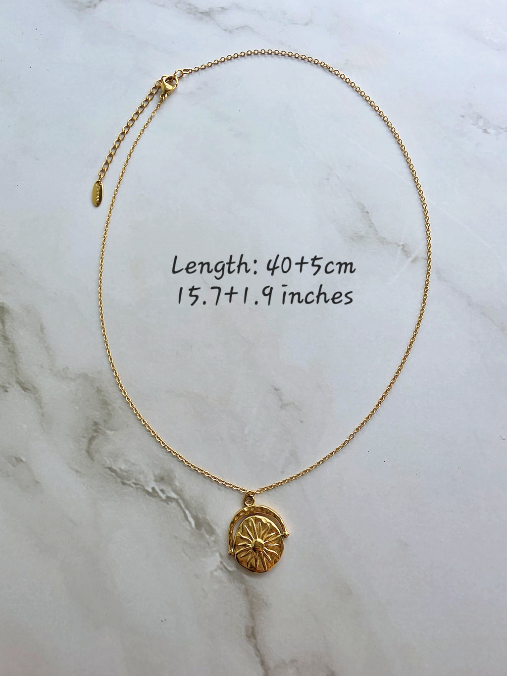 Celestial spinner necklace with a detailed sun and moon design.