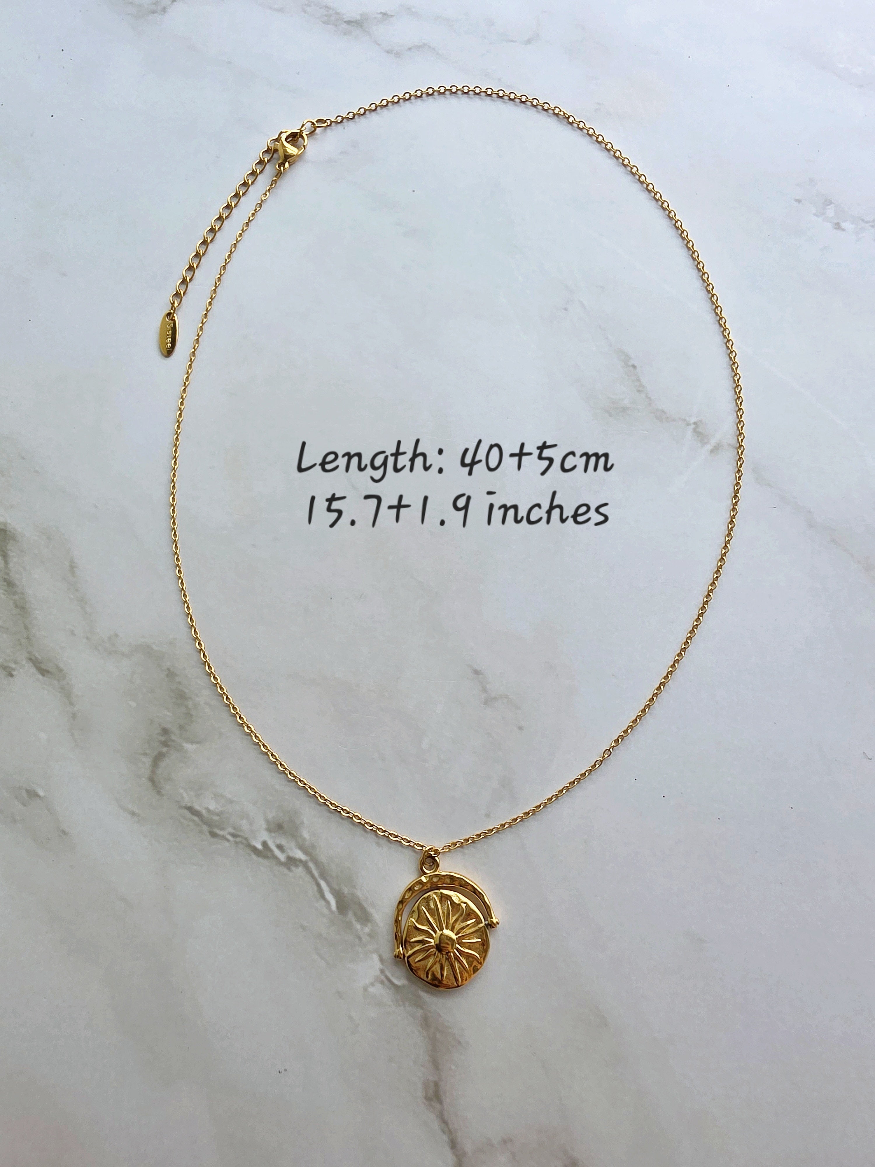 Celestial spinner necklace with a detailed sun and moon design.